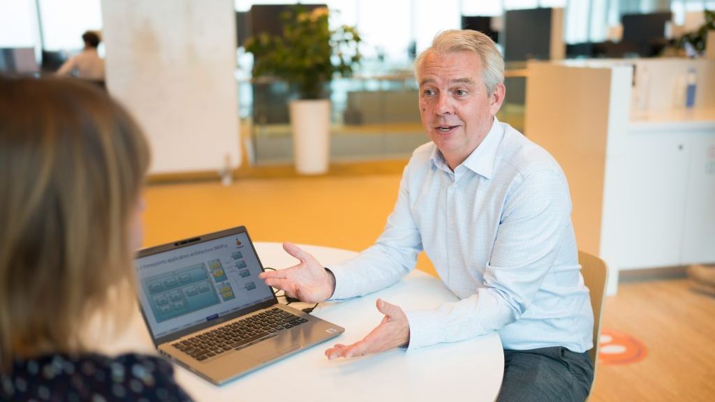 Man is showing something on his laptop