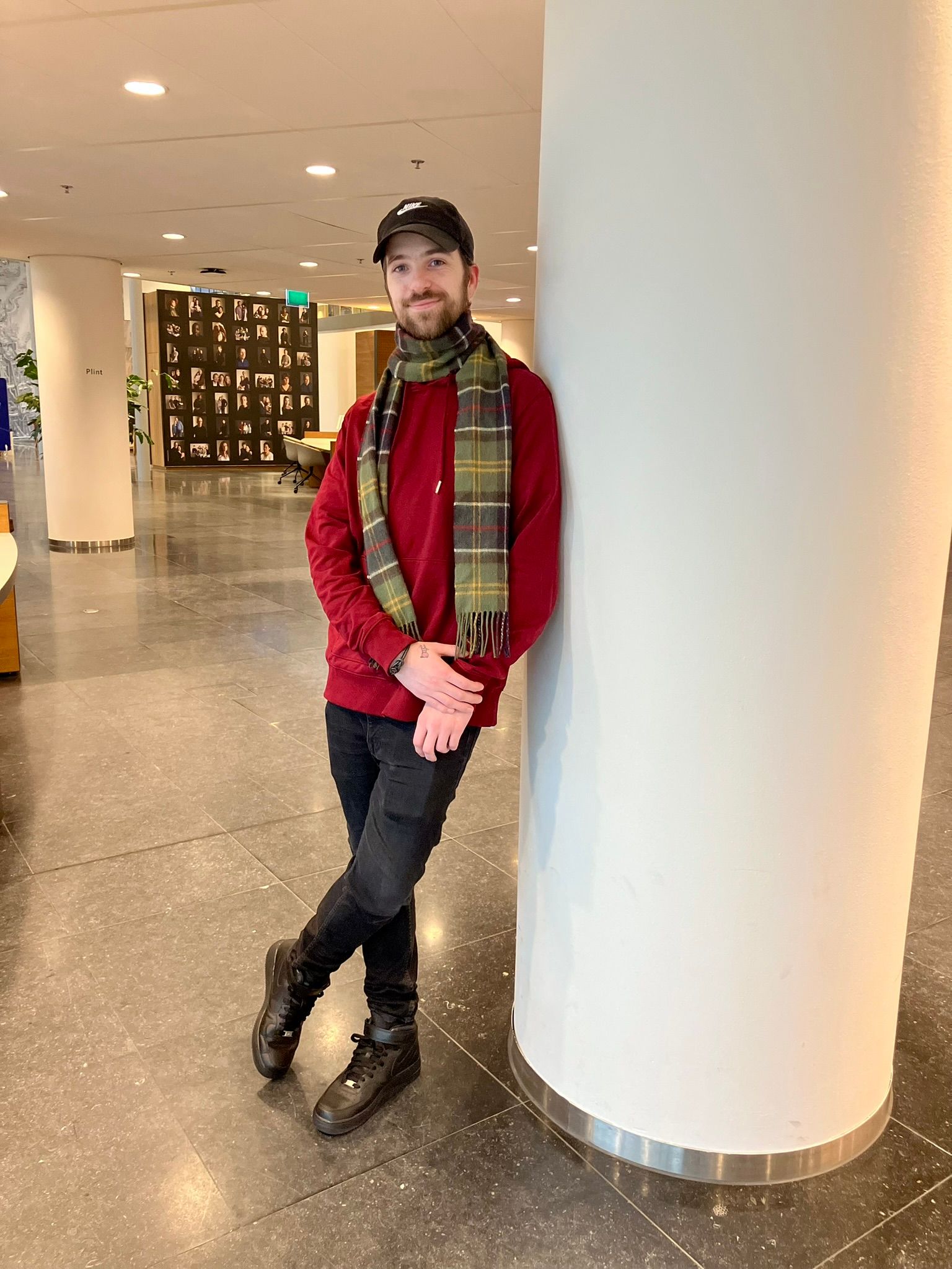 man wearing red sweater, scarf and a cap