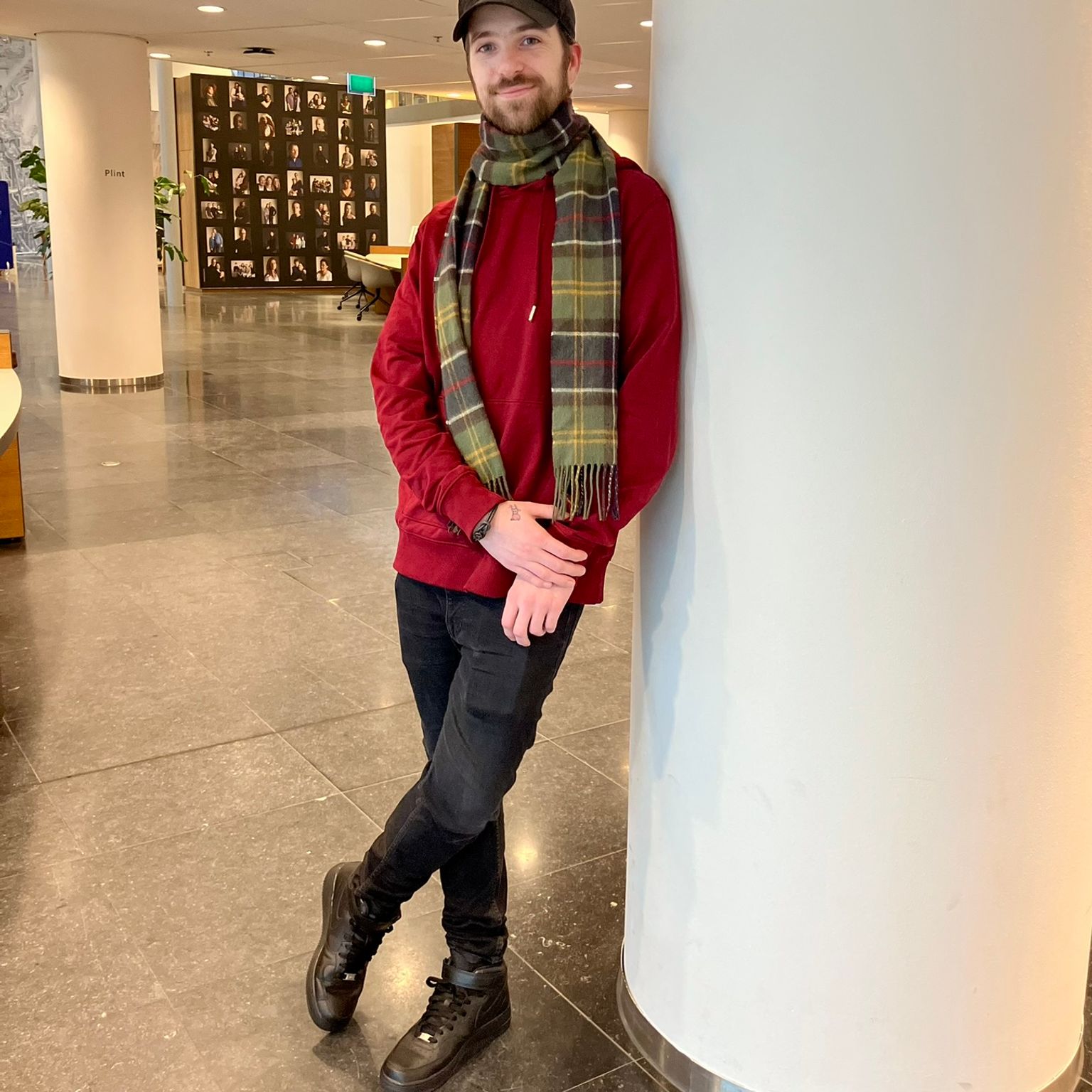 man wearing red sweater, scarf and a cap