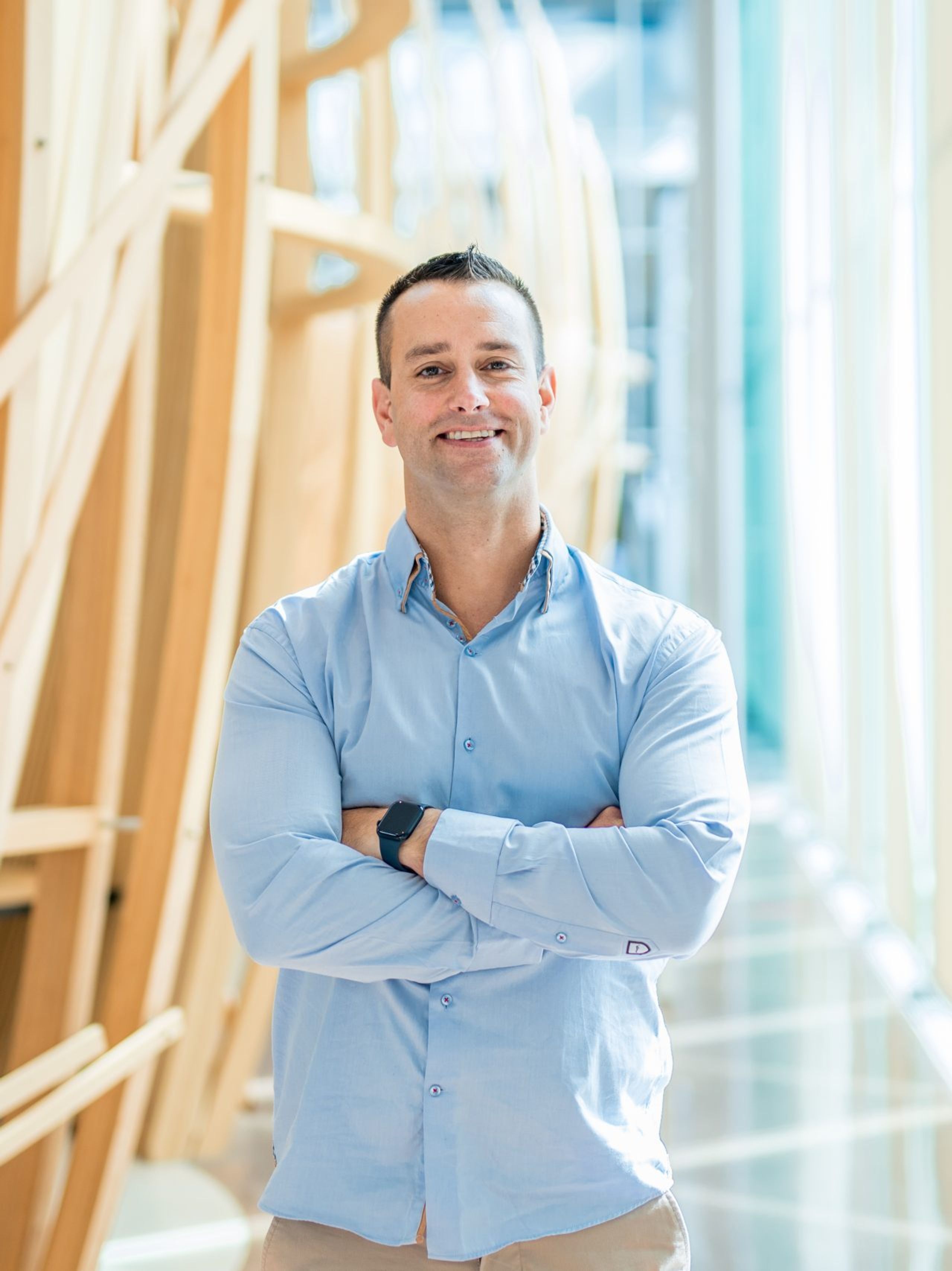 Man proudly poses with arms crossed