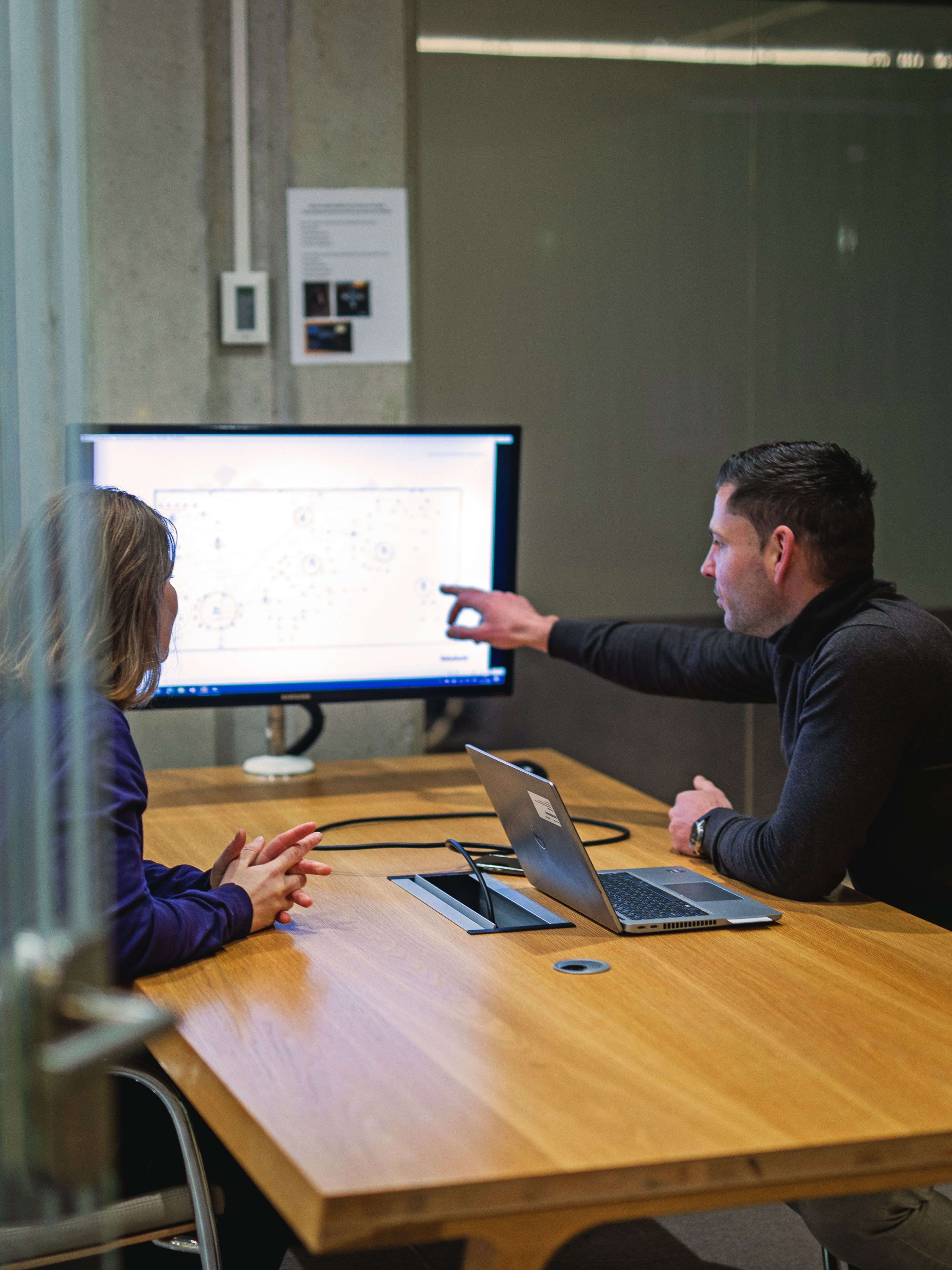 man and woman in meeting room