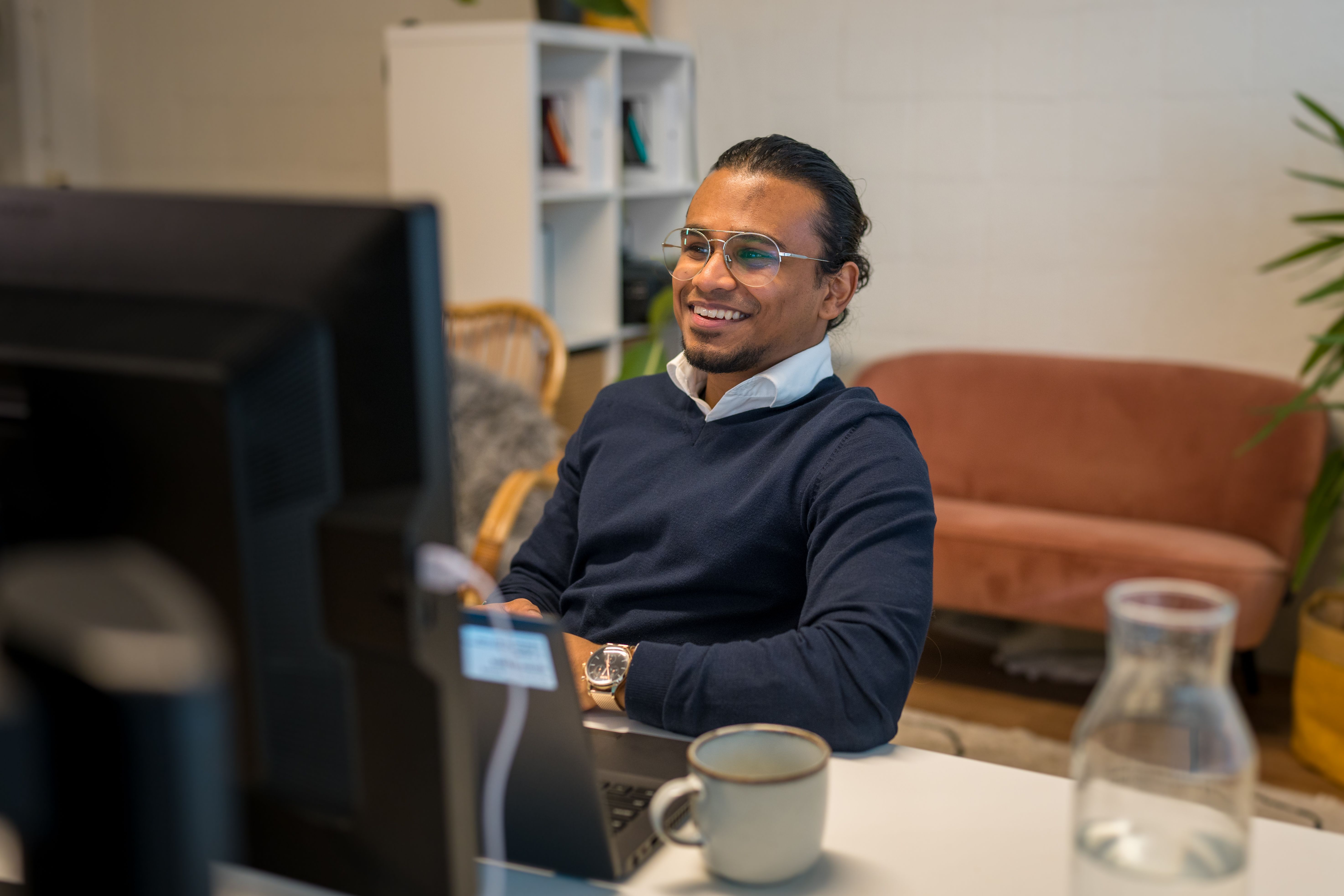 Aiji Loganathan sitting behind his laptop