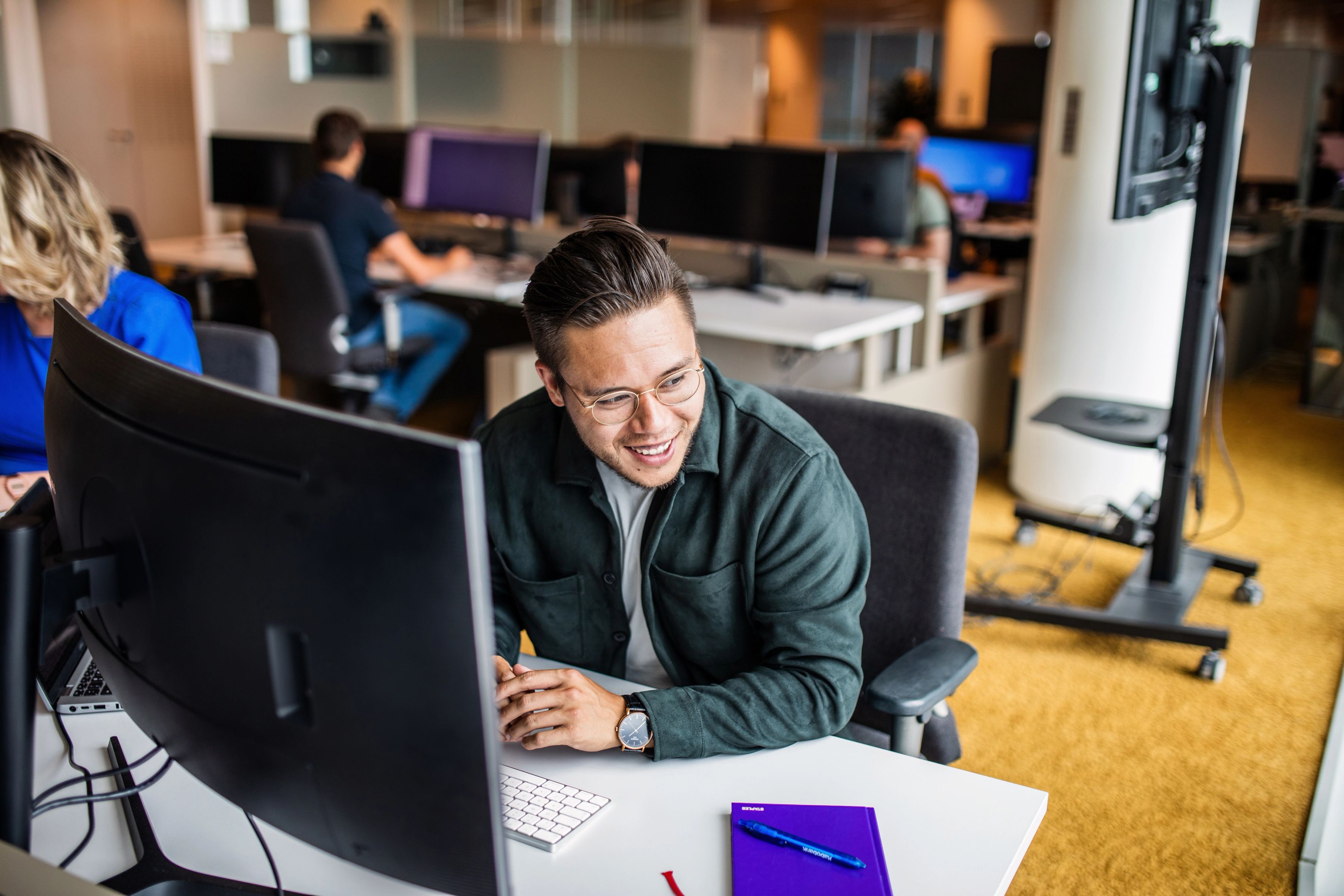 Two young professionals looking at computer