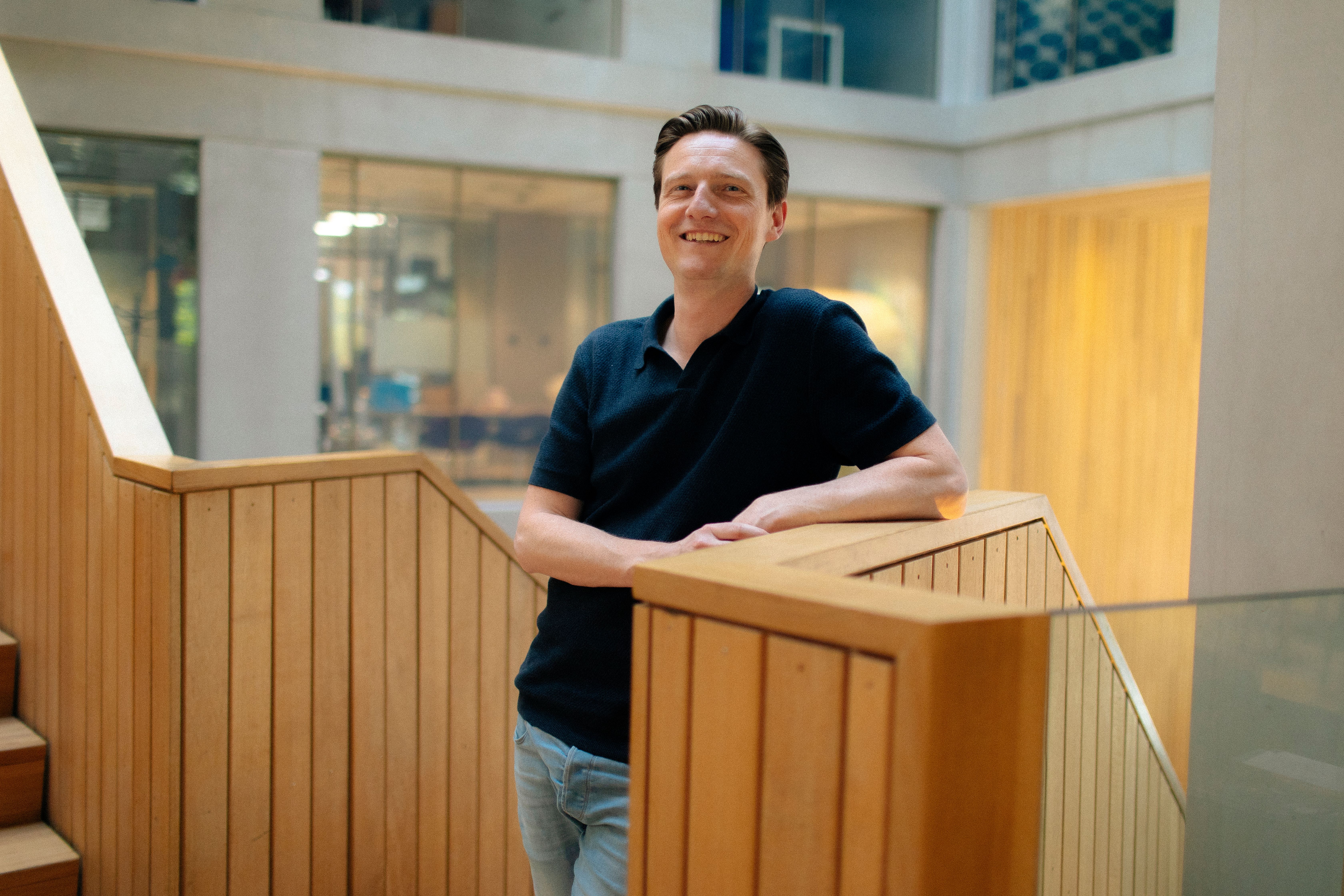 man standing next to a wooden board