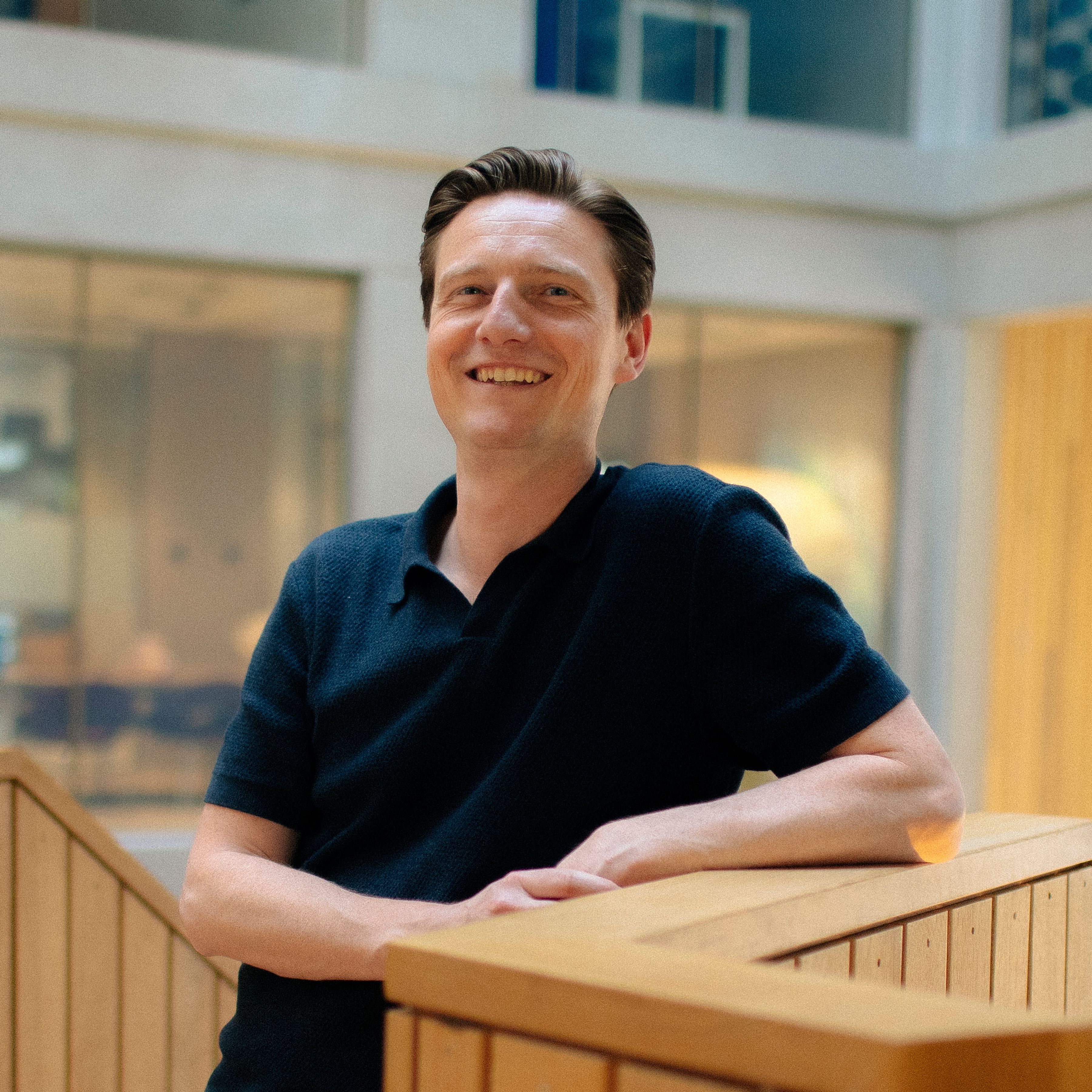 man standing next to a wooden board