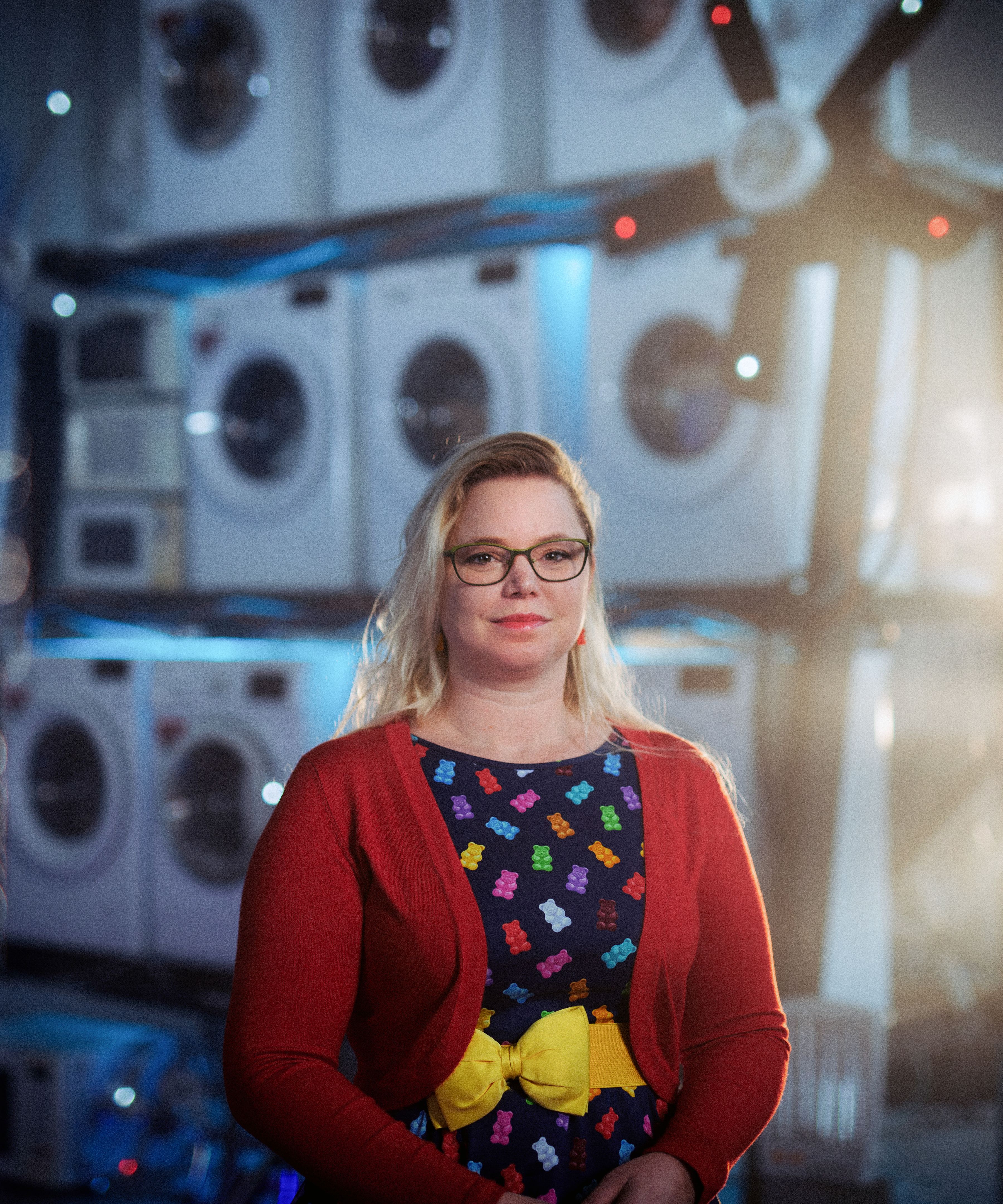 Woman in front of stacked washing machines