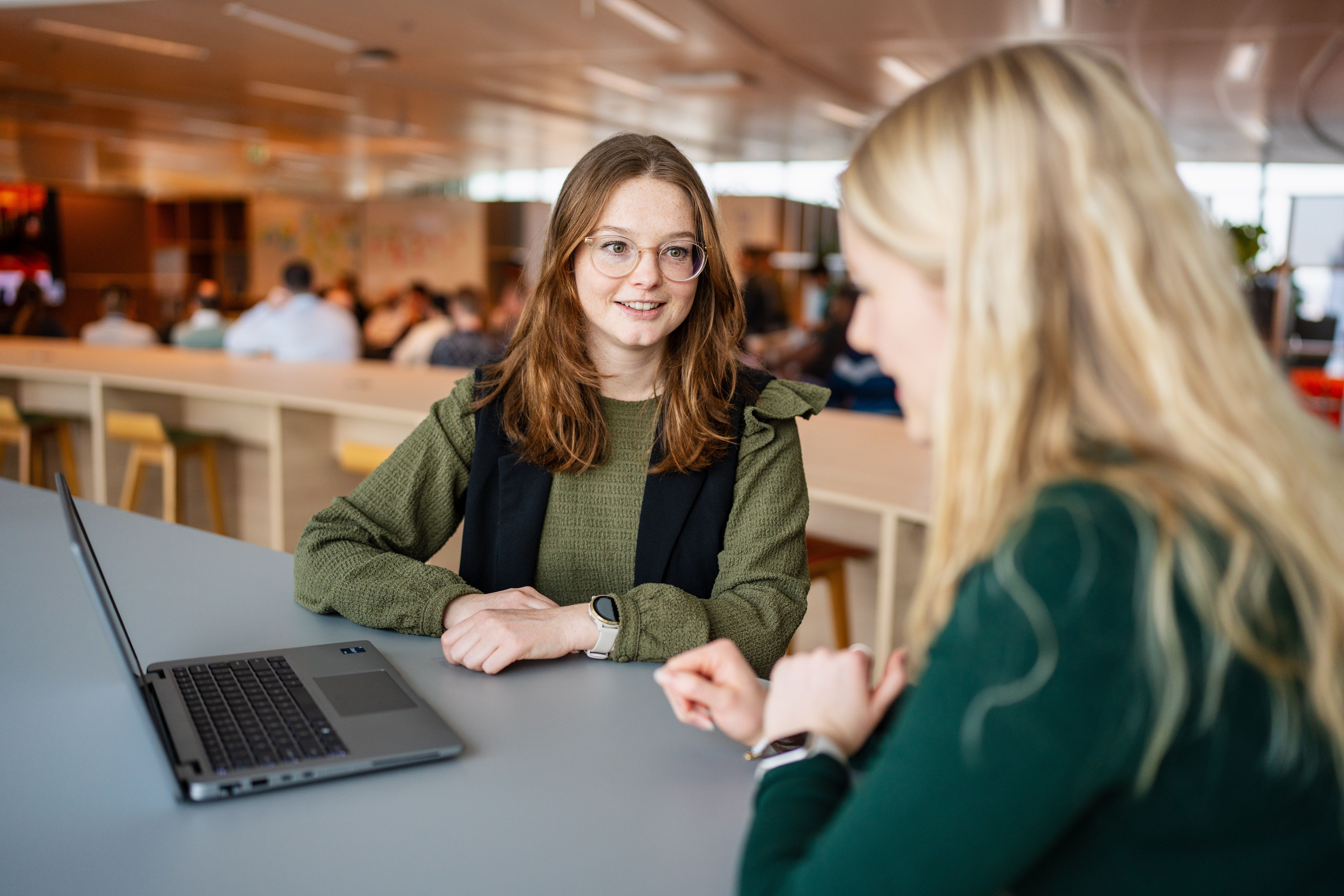 two women looking at a laptop