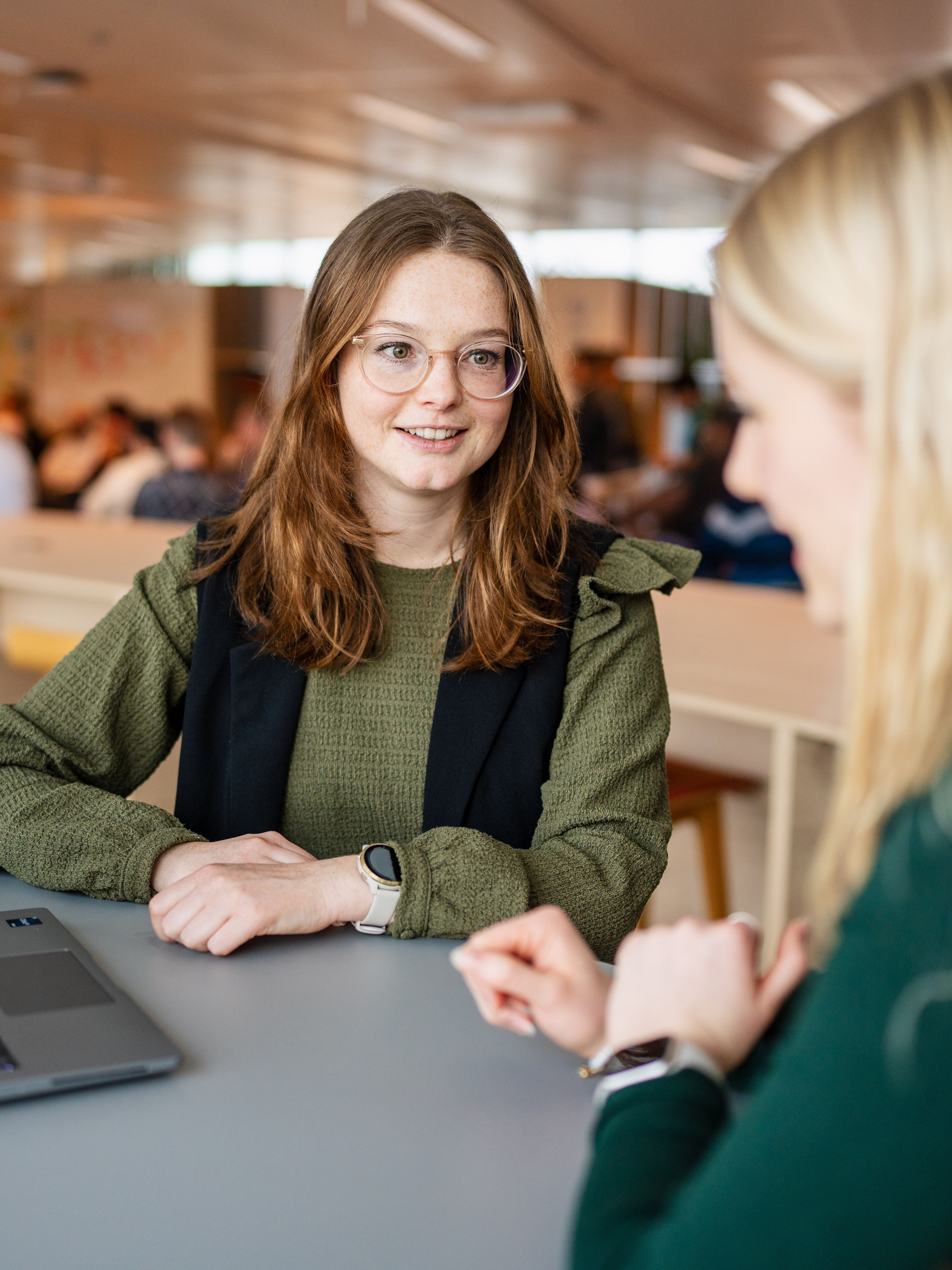 two women looking at a laptop