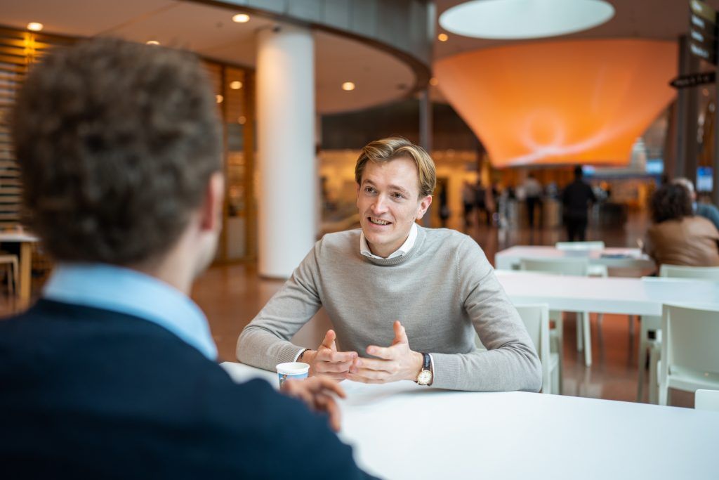 Young man talking with a colleague