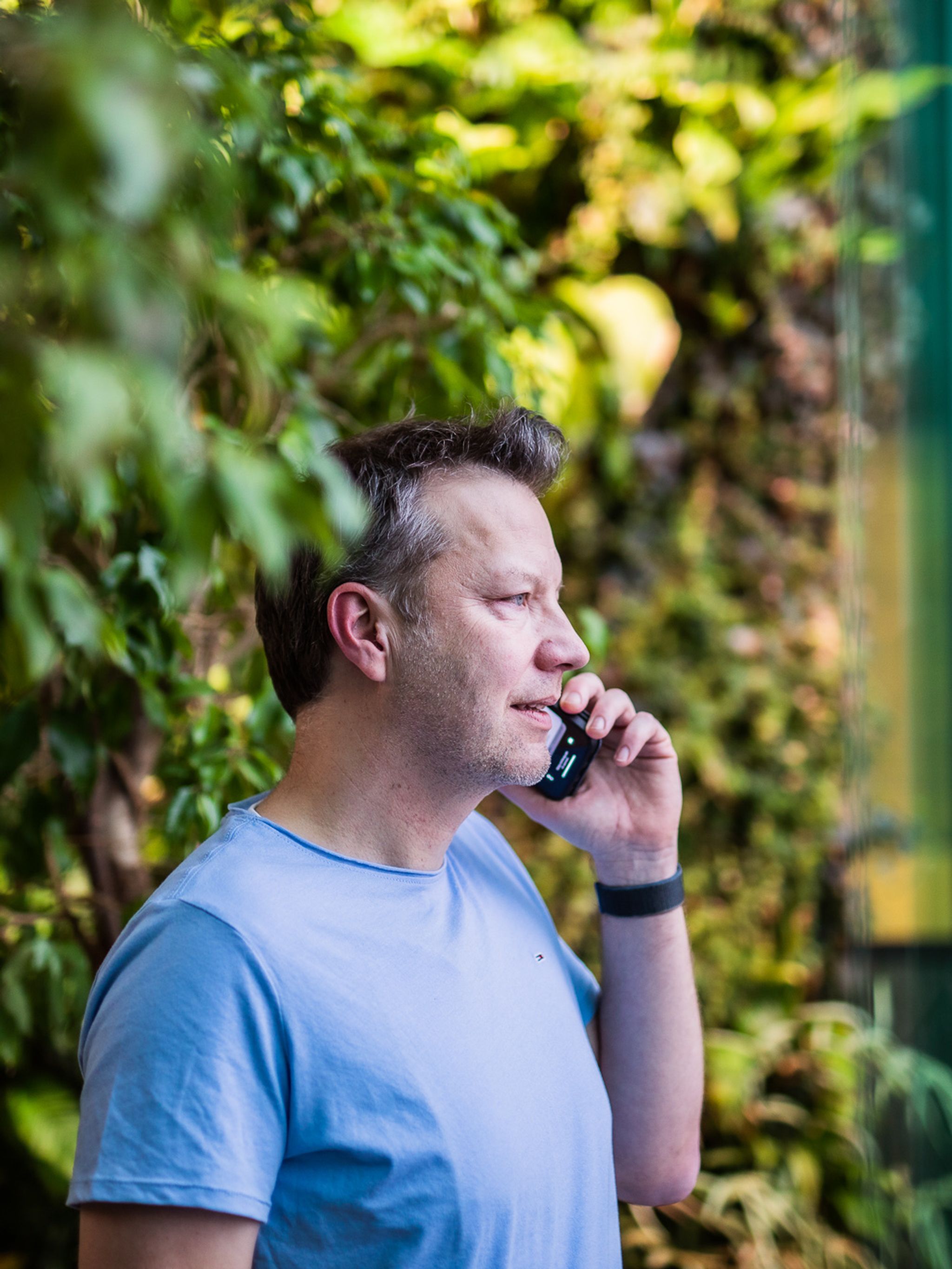 Chris calls at the office in a room with plants