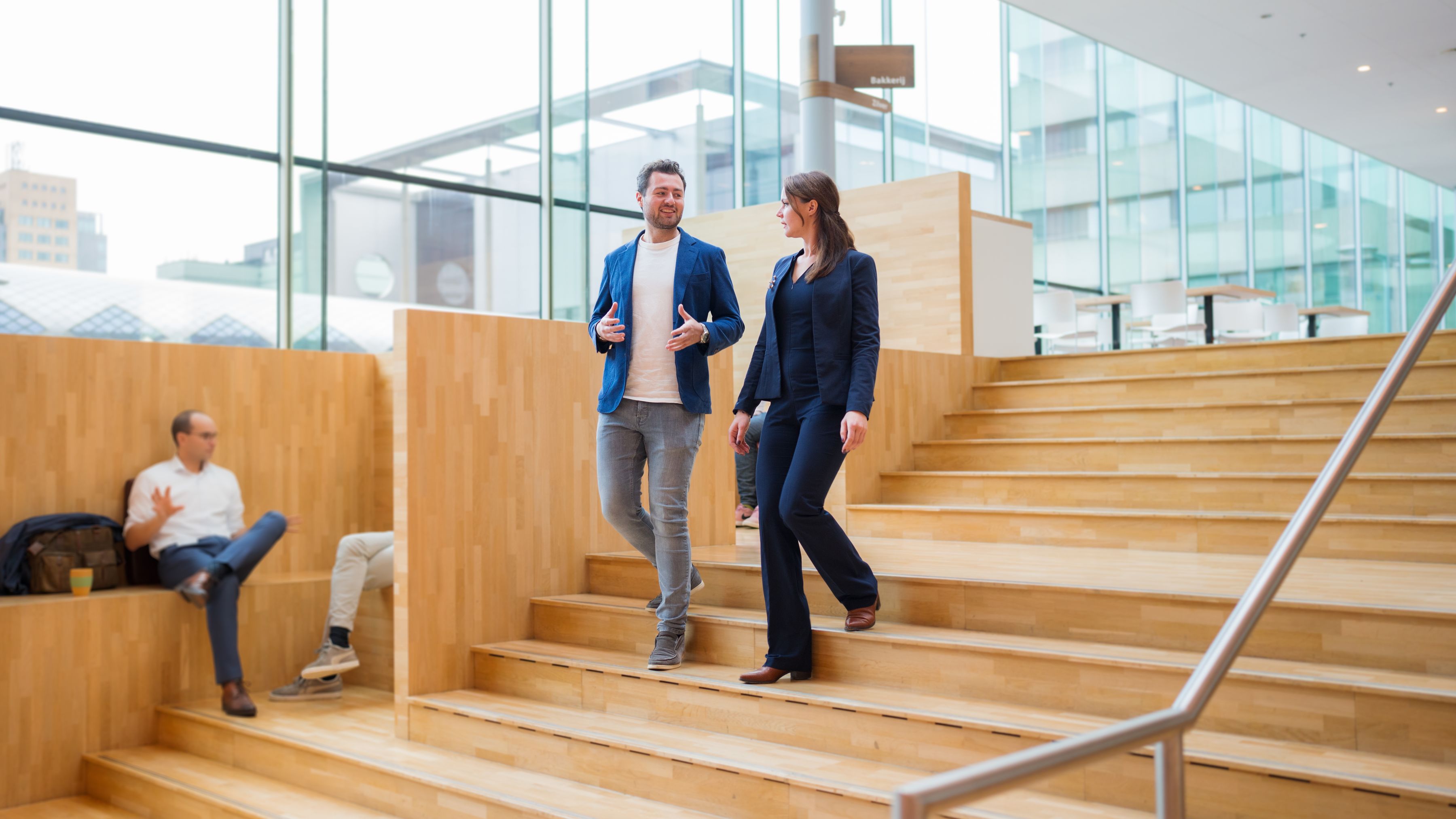 two colleagues walking up the stairs