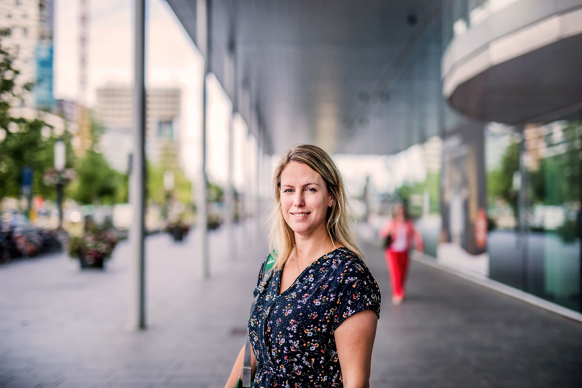 Vrouw staat buiten en kijkt naar camera