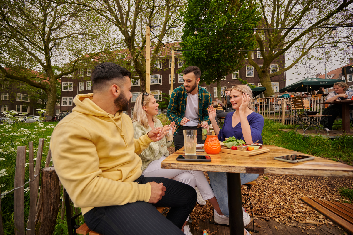 mensen ontspannen aan tafel buiten
