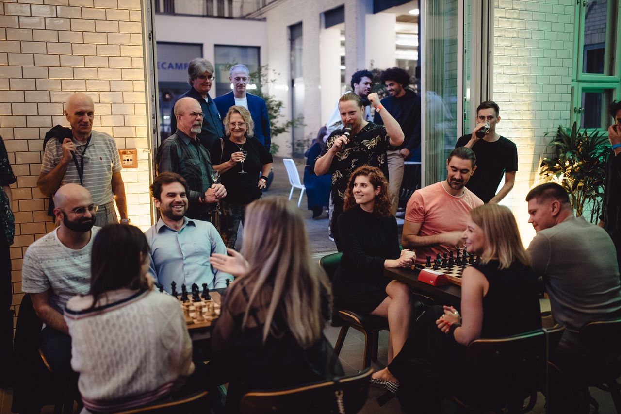 A group of people celebrating and playing chess