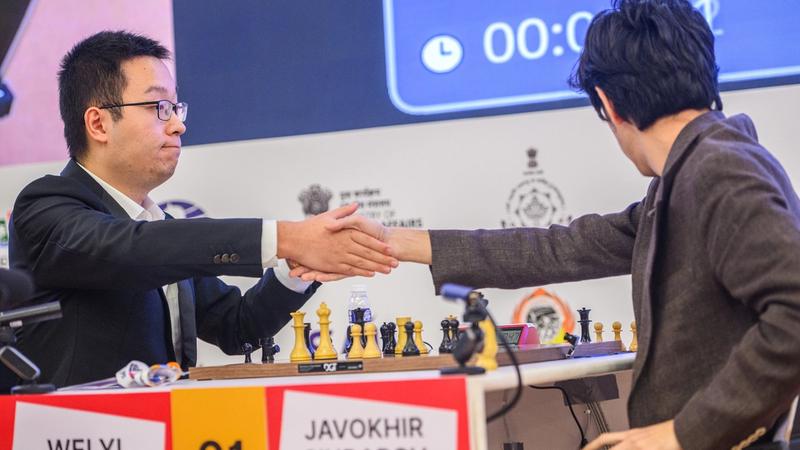 The moment of victory: GM Wei Yi extends his hand. 