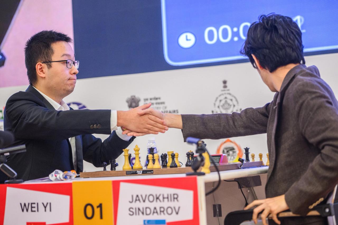 The moment of victory: GM Wei Yi extends his hand.