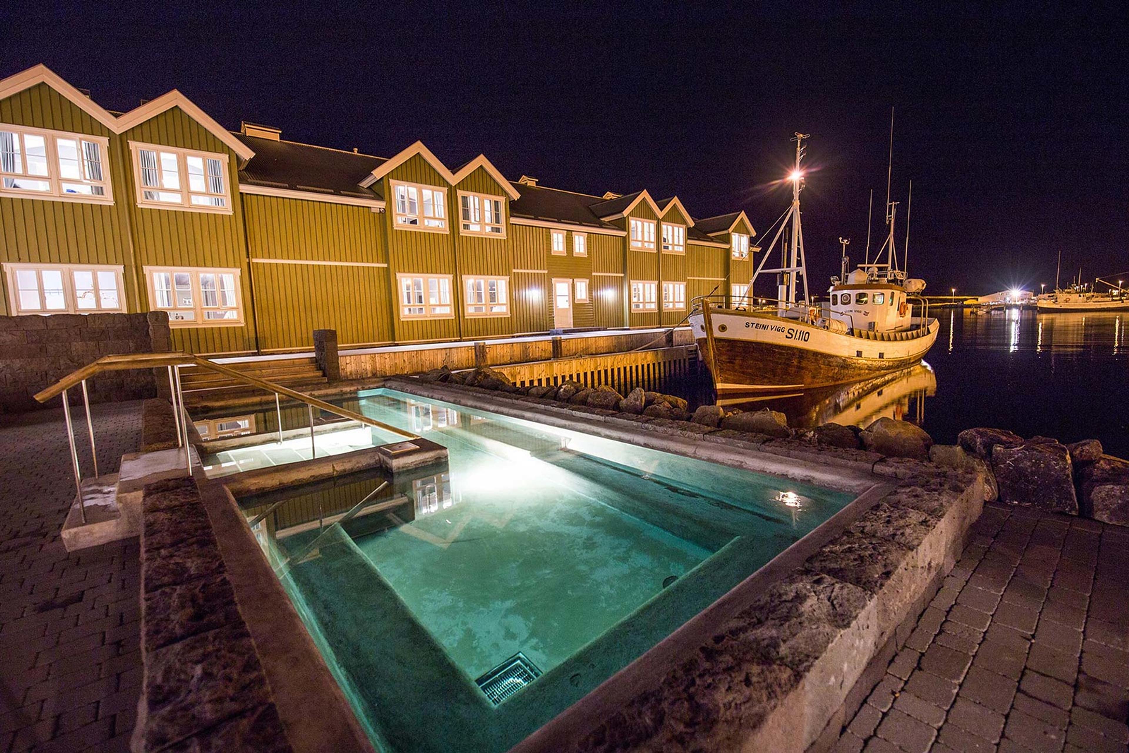 Outside of Siglo Hotel during the night with the hot tub lit up