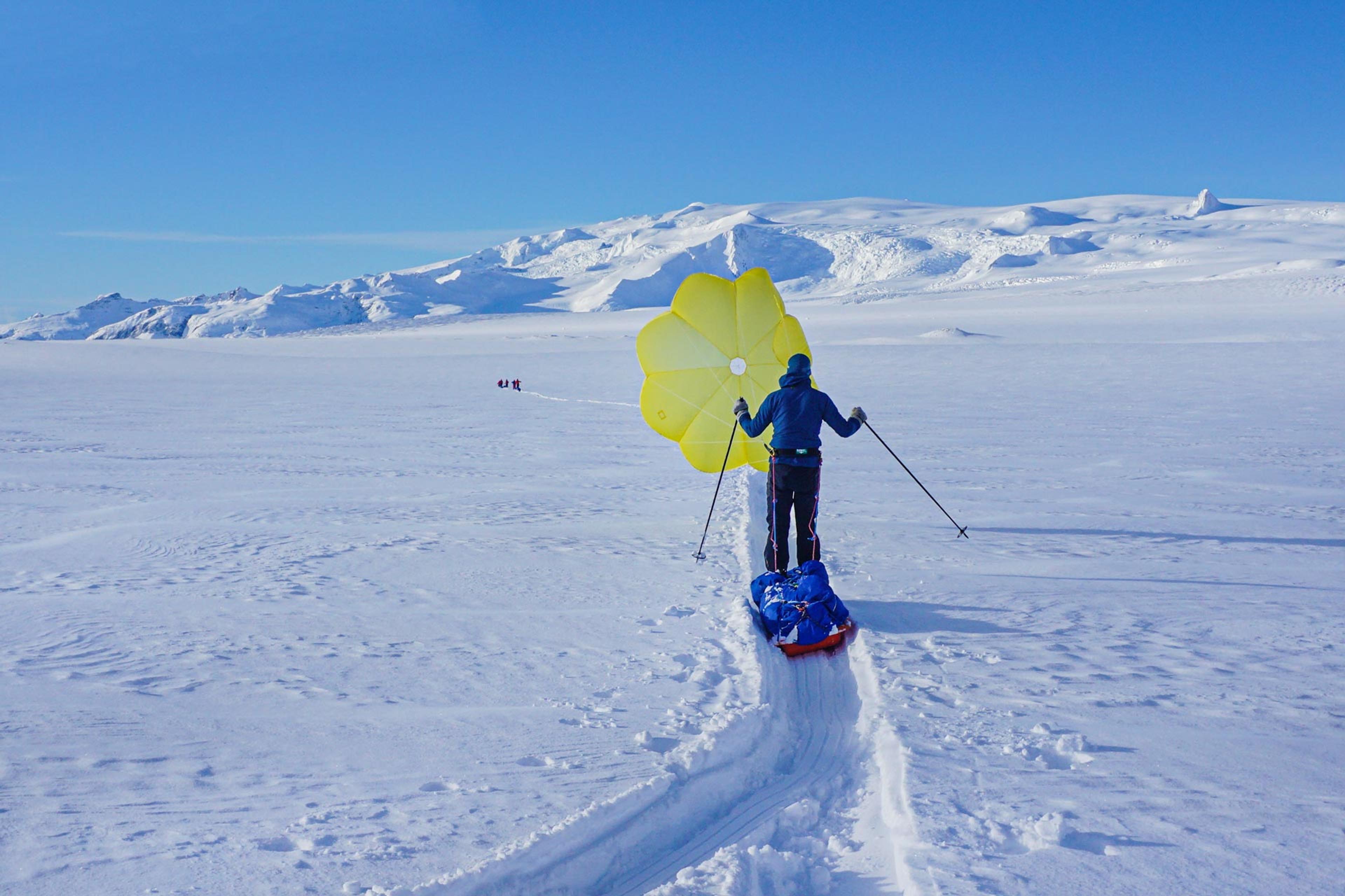 Man on skis using a yellow kite for assistance