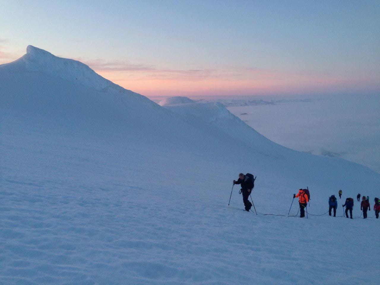 A group of hikers hiking the snowy hills of Snæfellsjökull glacier on a tour with Icelandic Mountain Guides