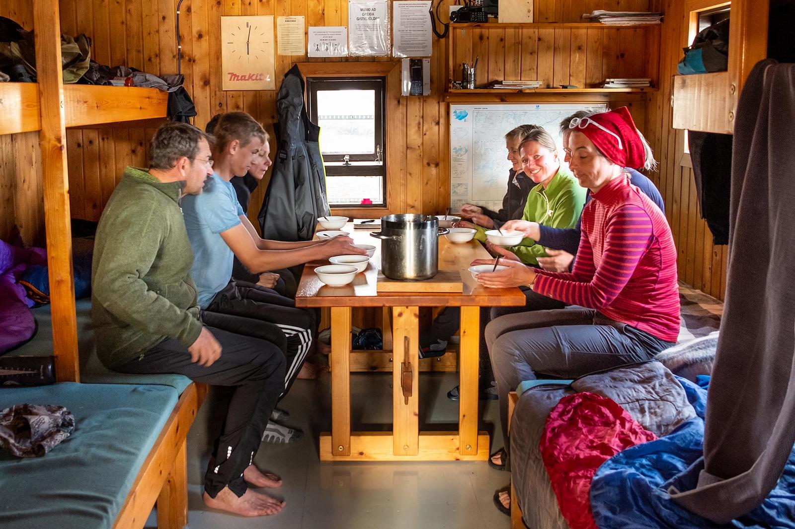 People having a soup inside a mountain hut in the icelandic highlands