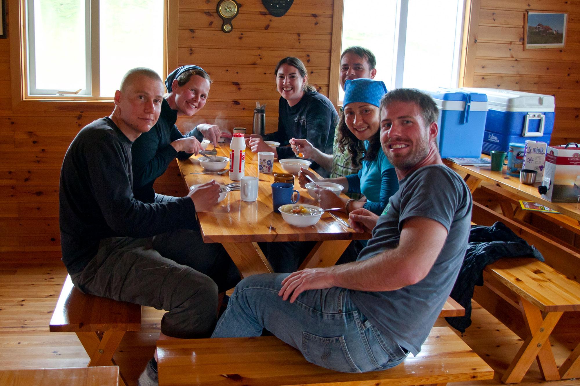 Happy people eating lunch inside an Icelandic hut