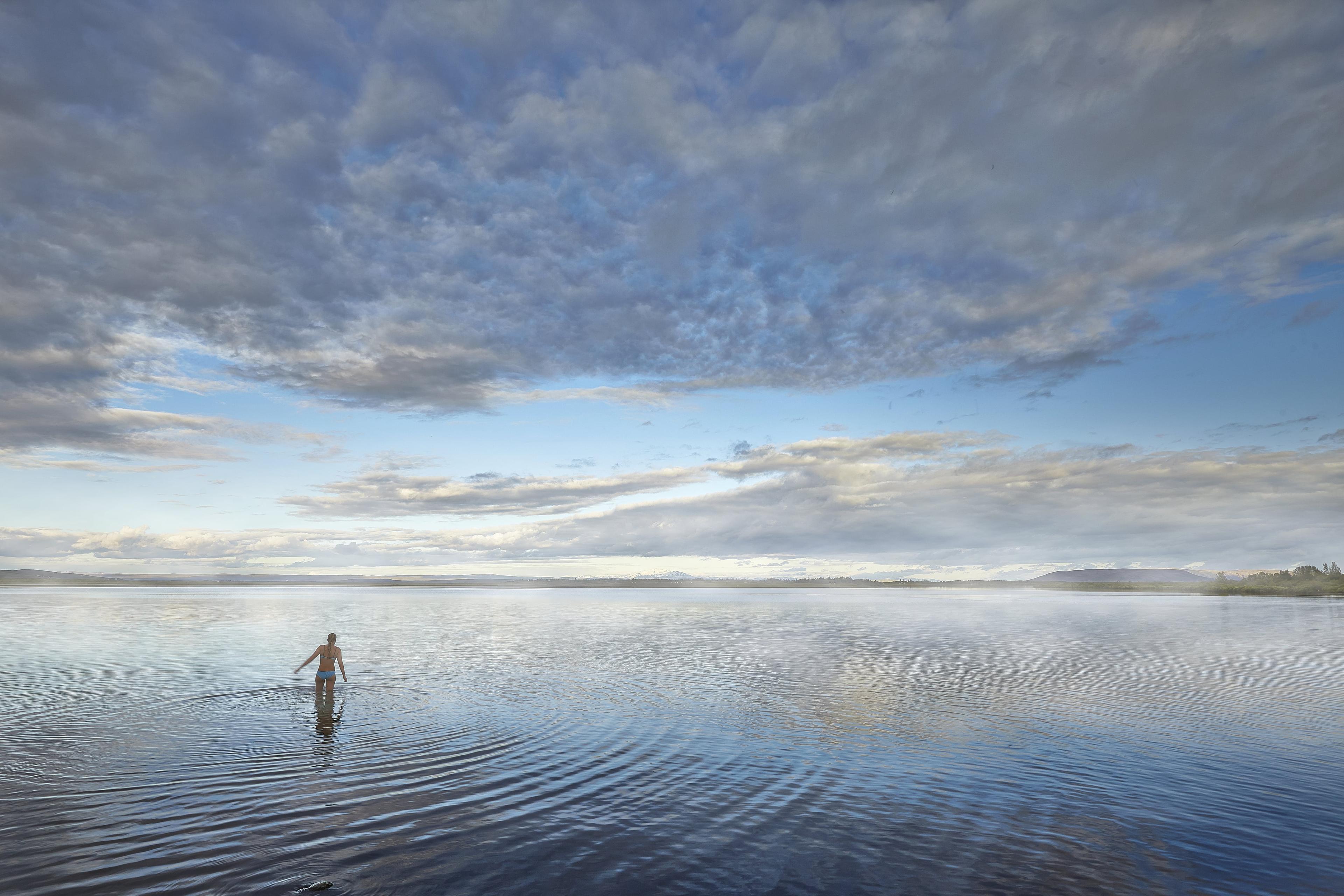 A woman bathing in the Laugarvatn lake next to Fontana geothermal baths.