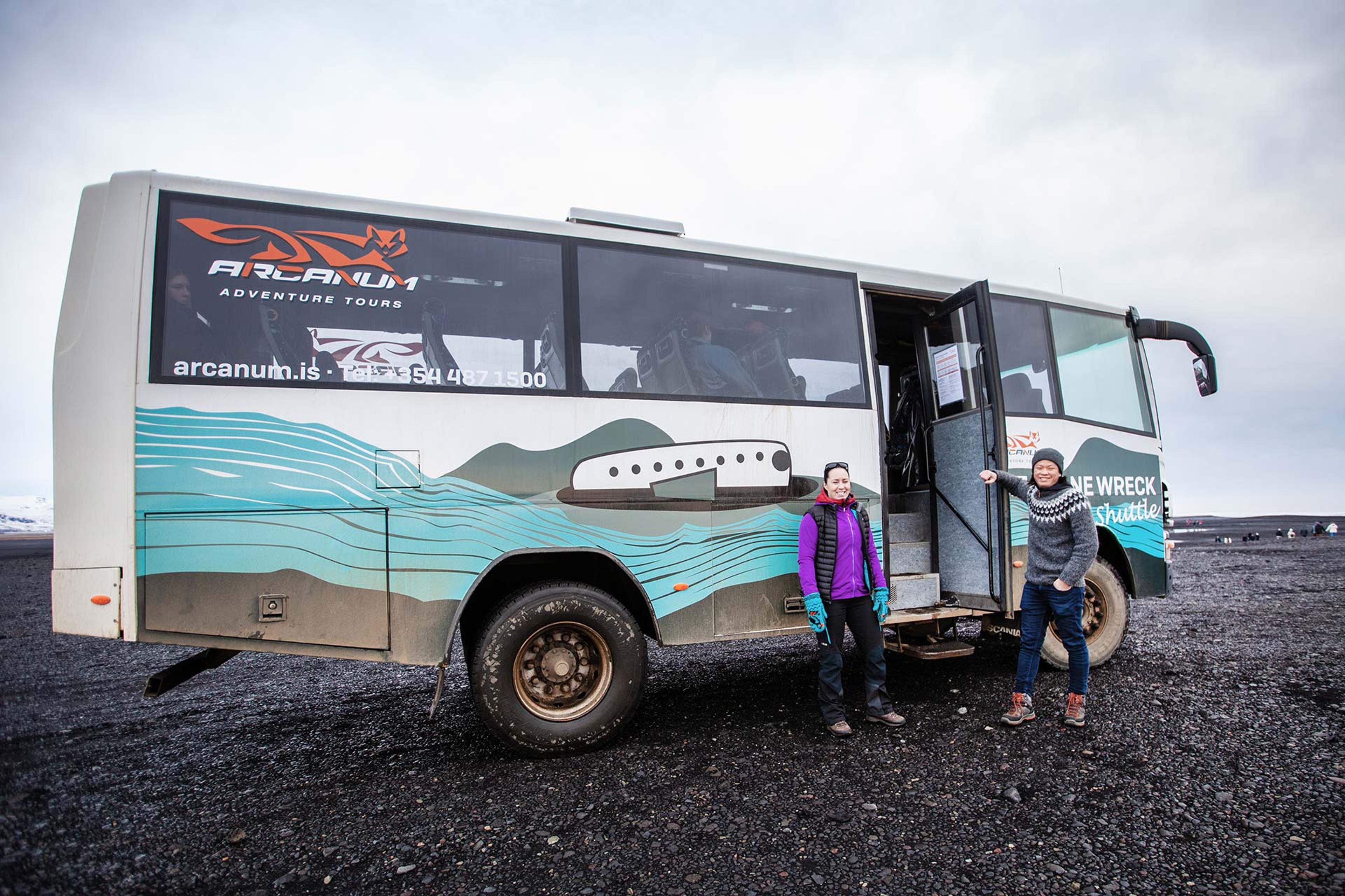 A couple getting aboard on the shuttle on the black sand 