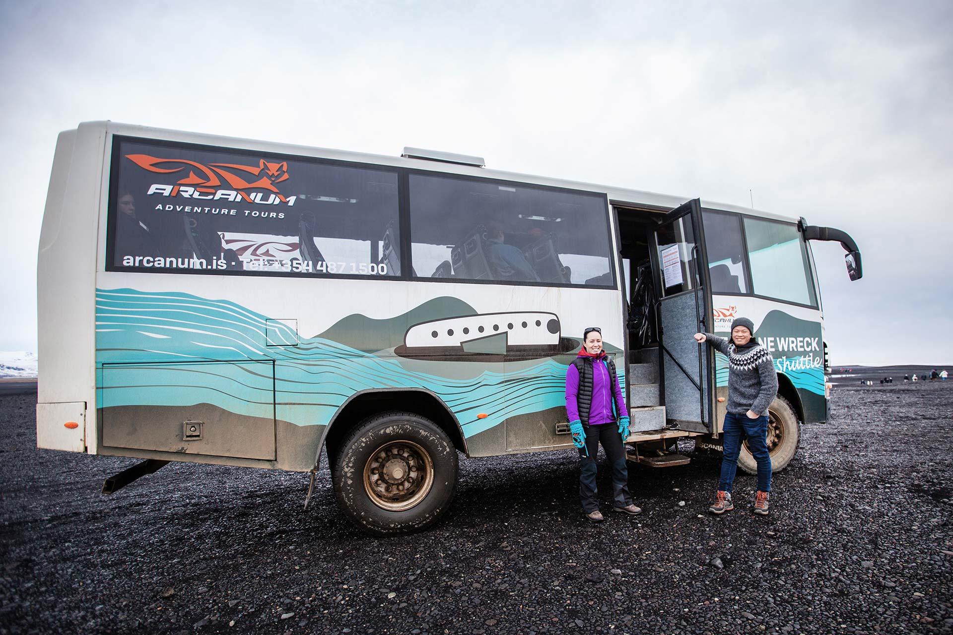 A couple getting aboard on the shuttle on the black sand