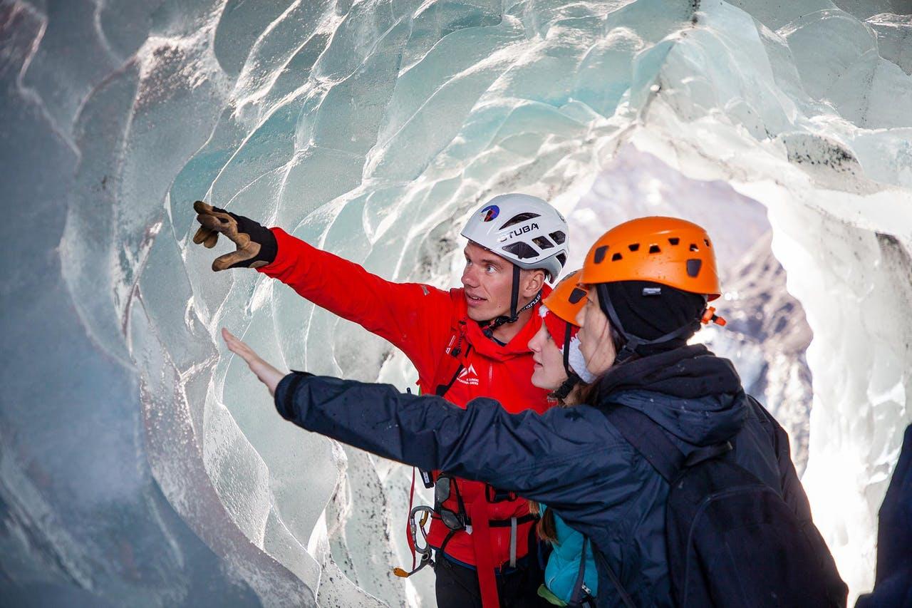 Guide telling about the glacier ice and the clients touching the ice