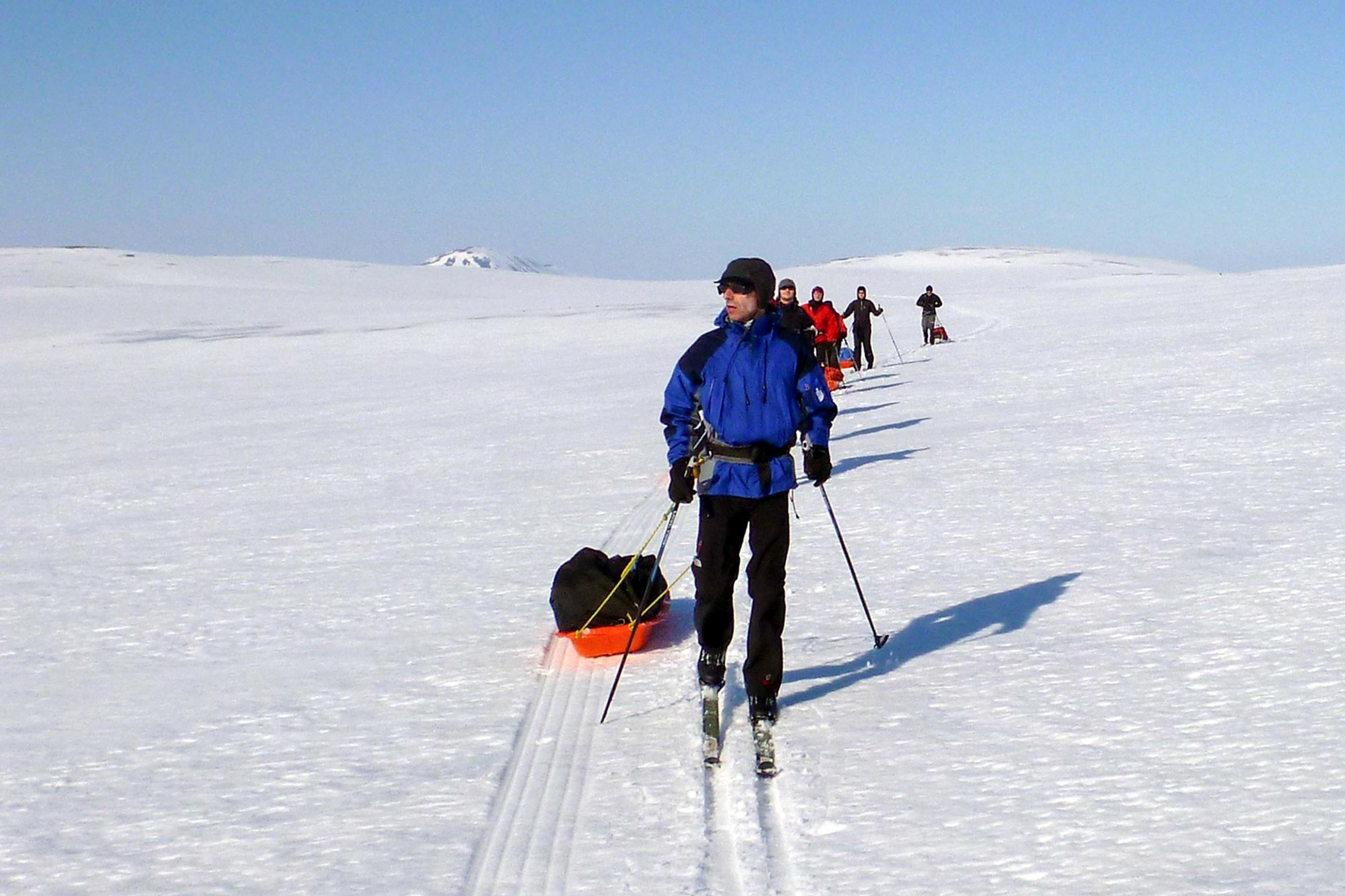 skiers on an expedition skiing in great sunny weather