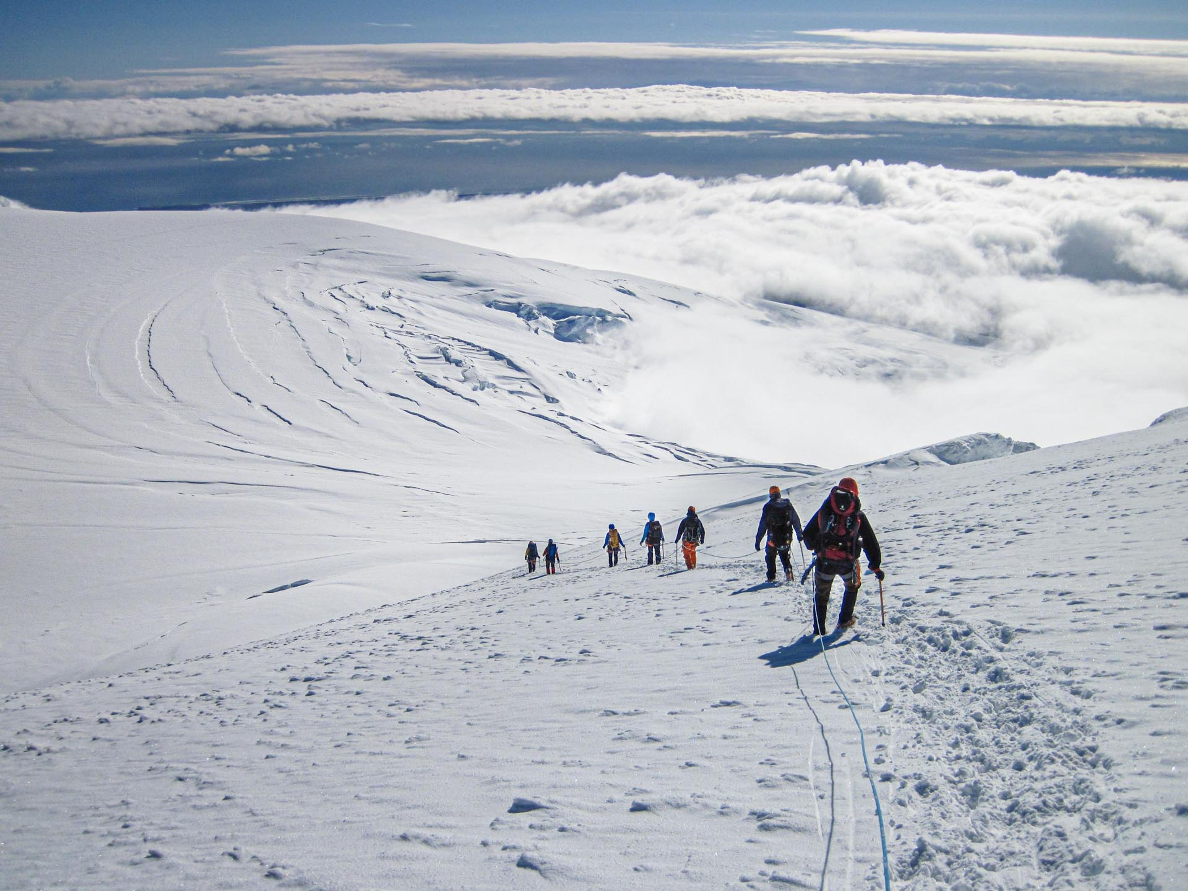 hikers going down a snowy slope