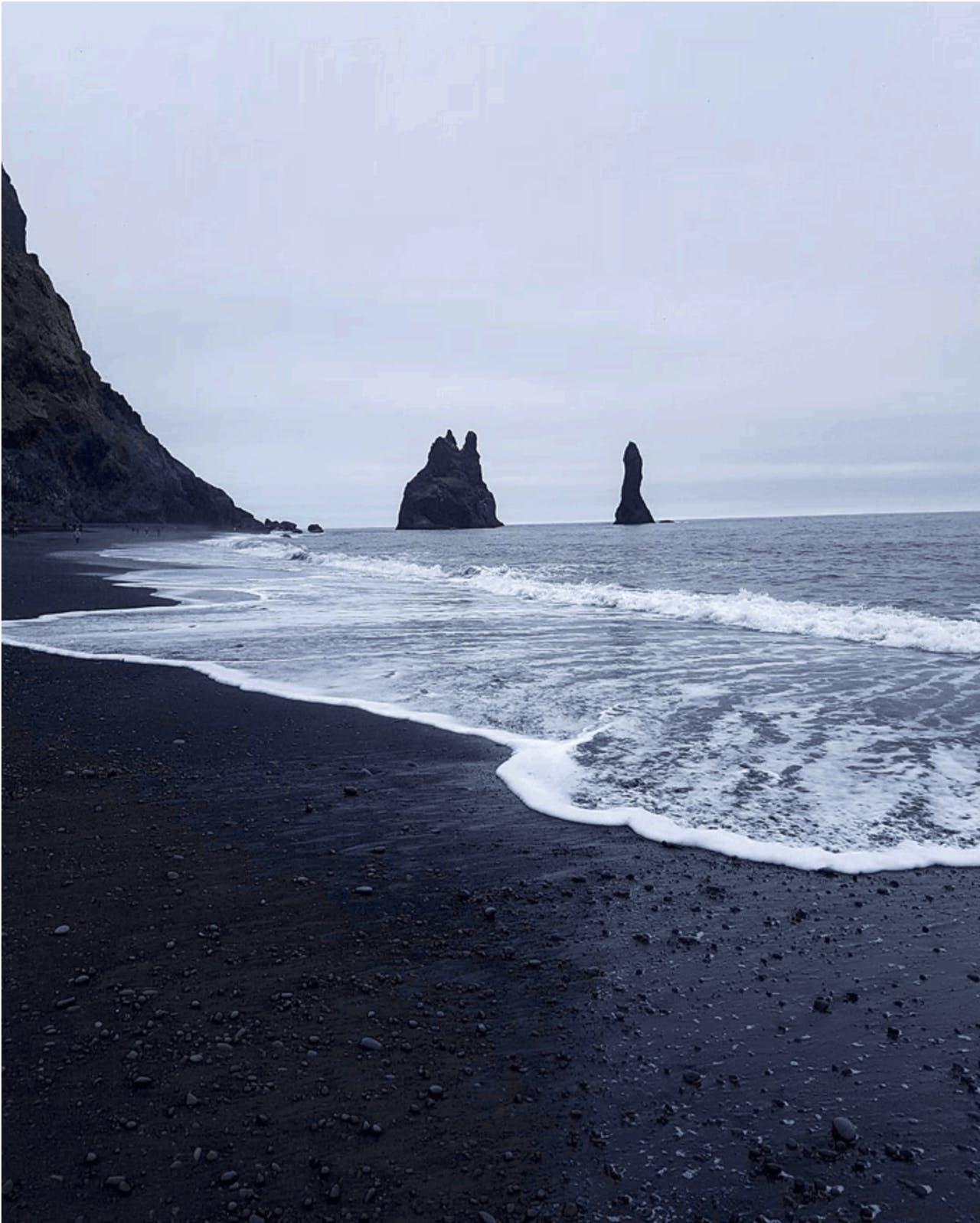 Reynisfjara black sand beach in Iceland on a foggy day