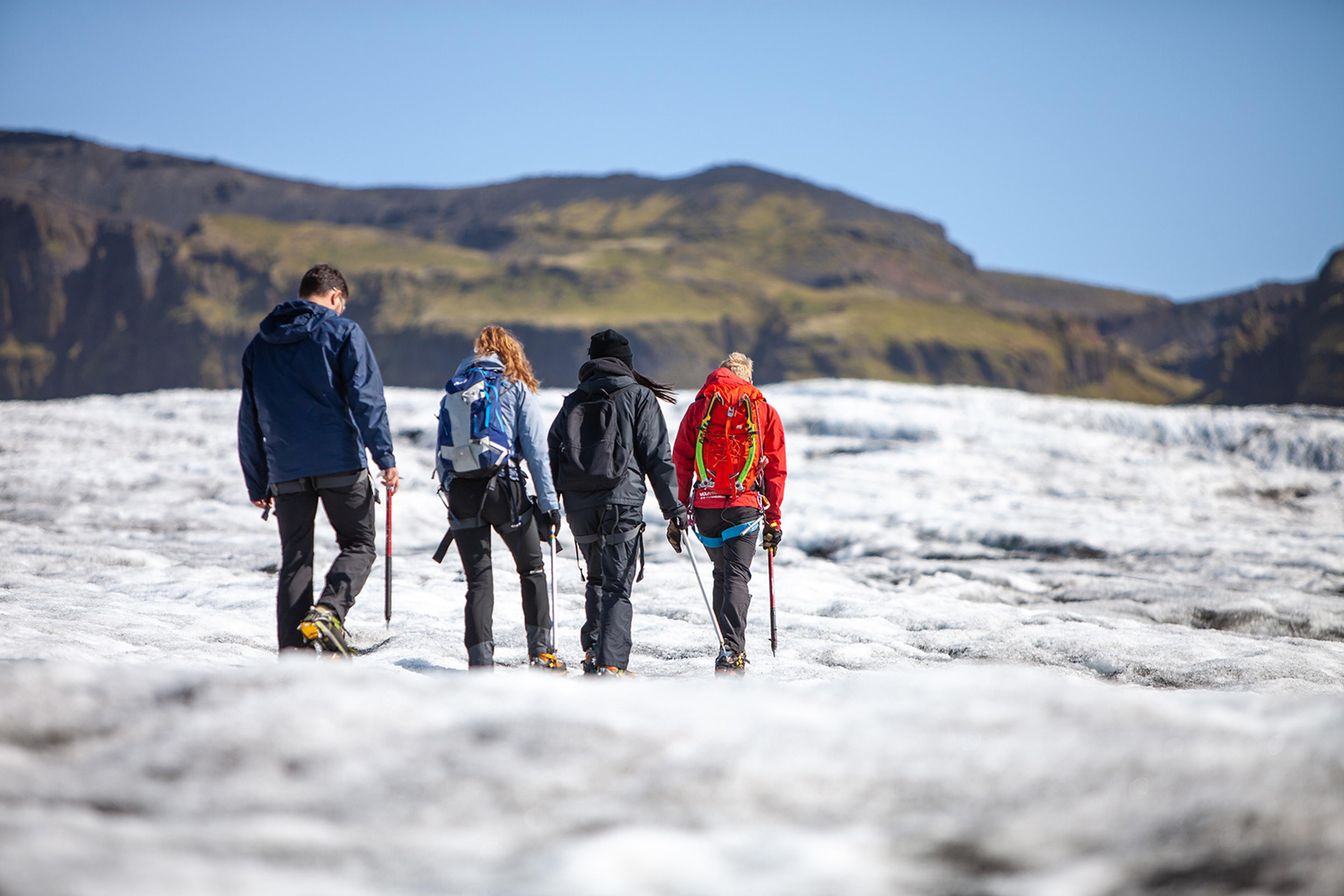 A group of people walking on the glacier tha falls from Myrdalsjokull glacier