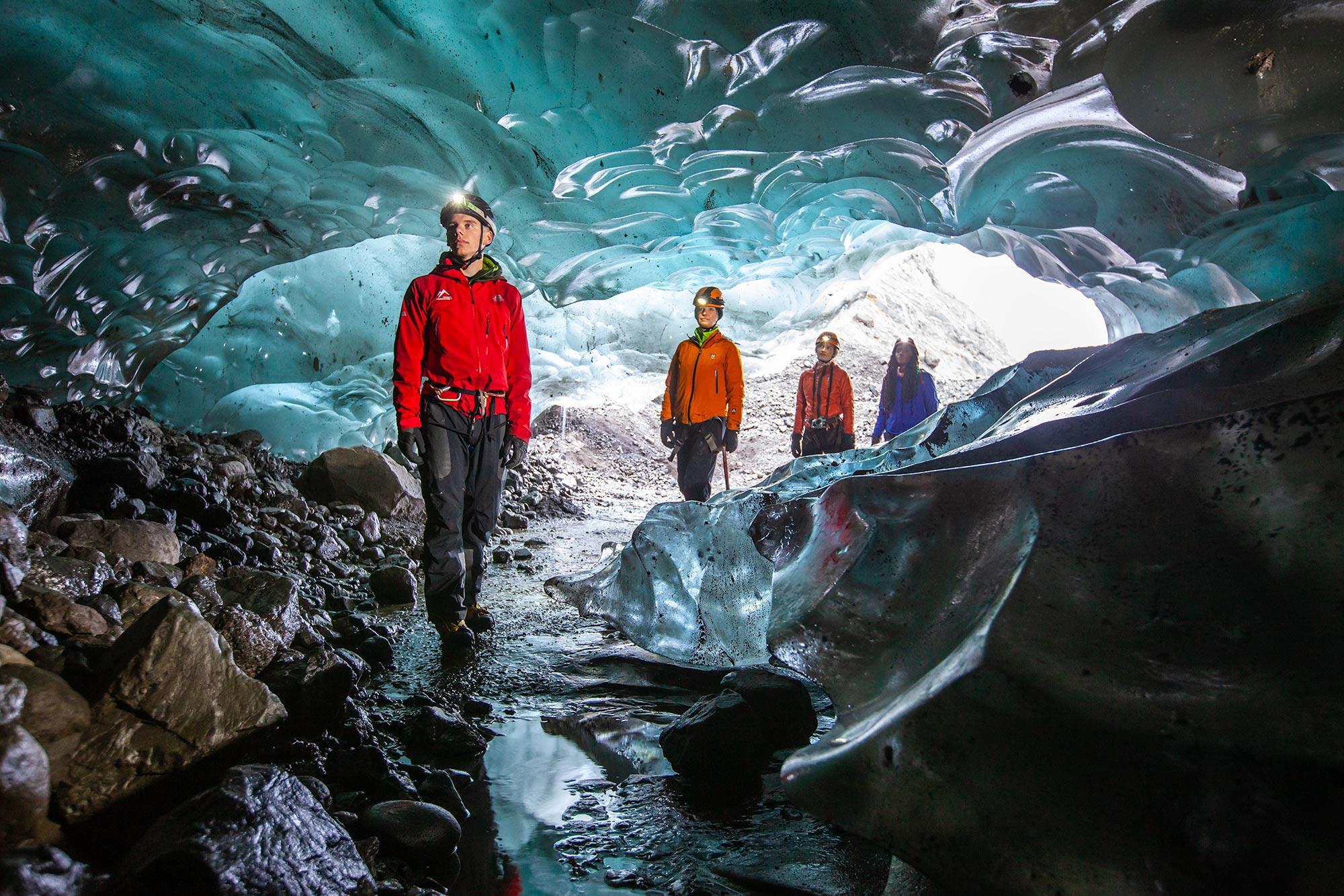 People entering a blue ice cave near Skaftafell