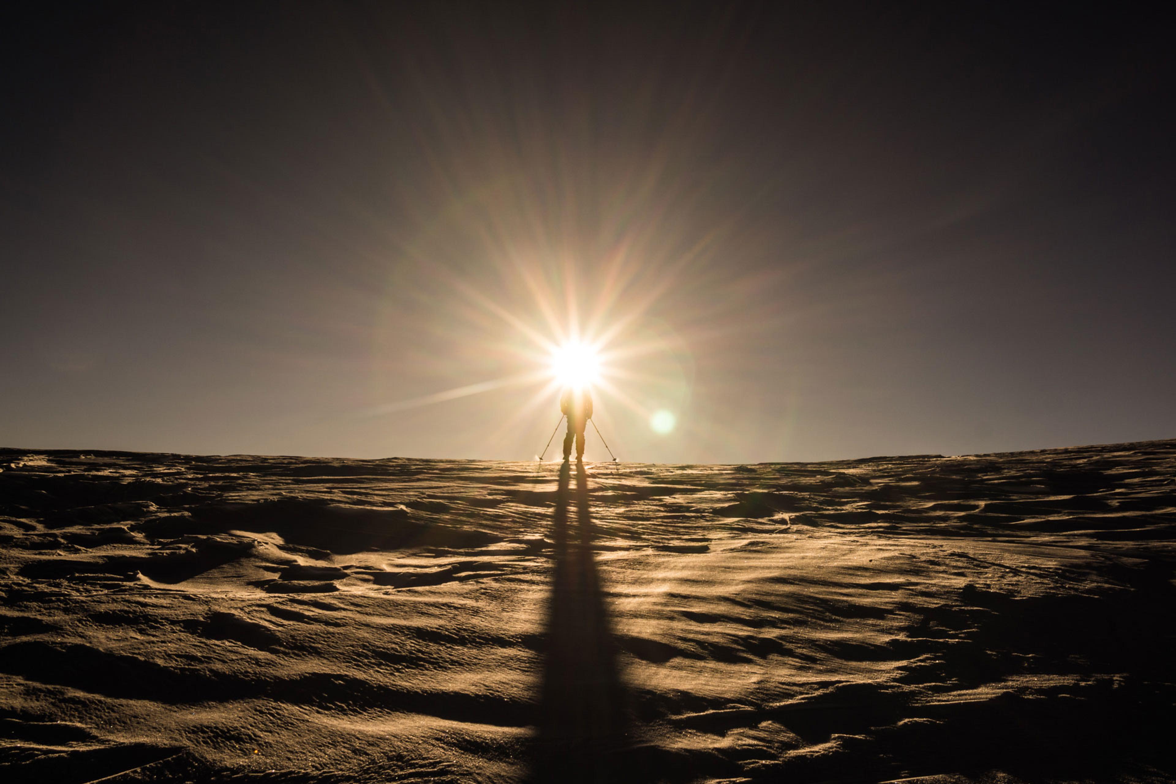 Skier and a massive sun star photo effect around his head