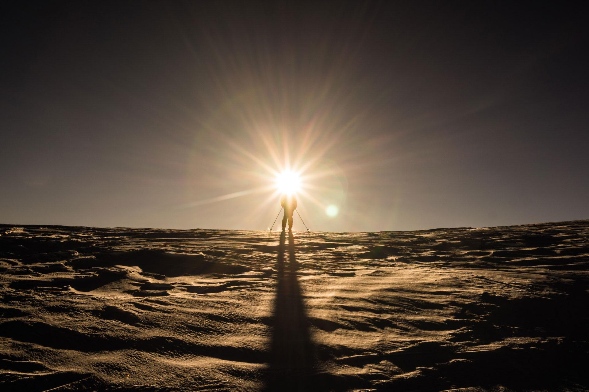Skier and a massive sun star photo effect around his head