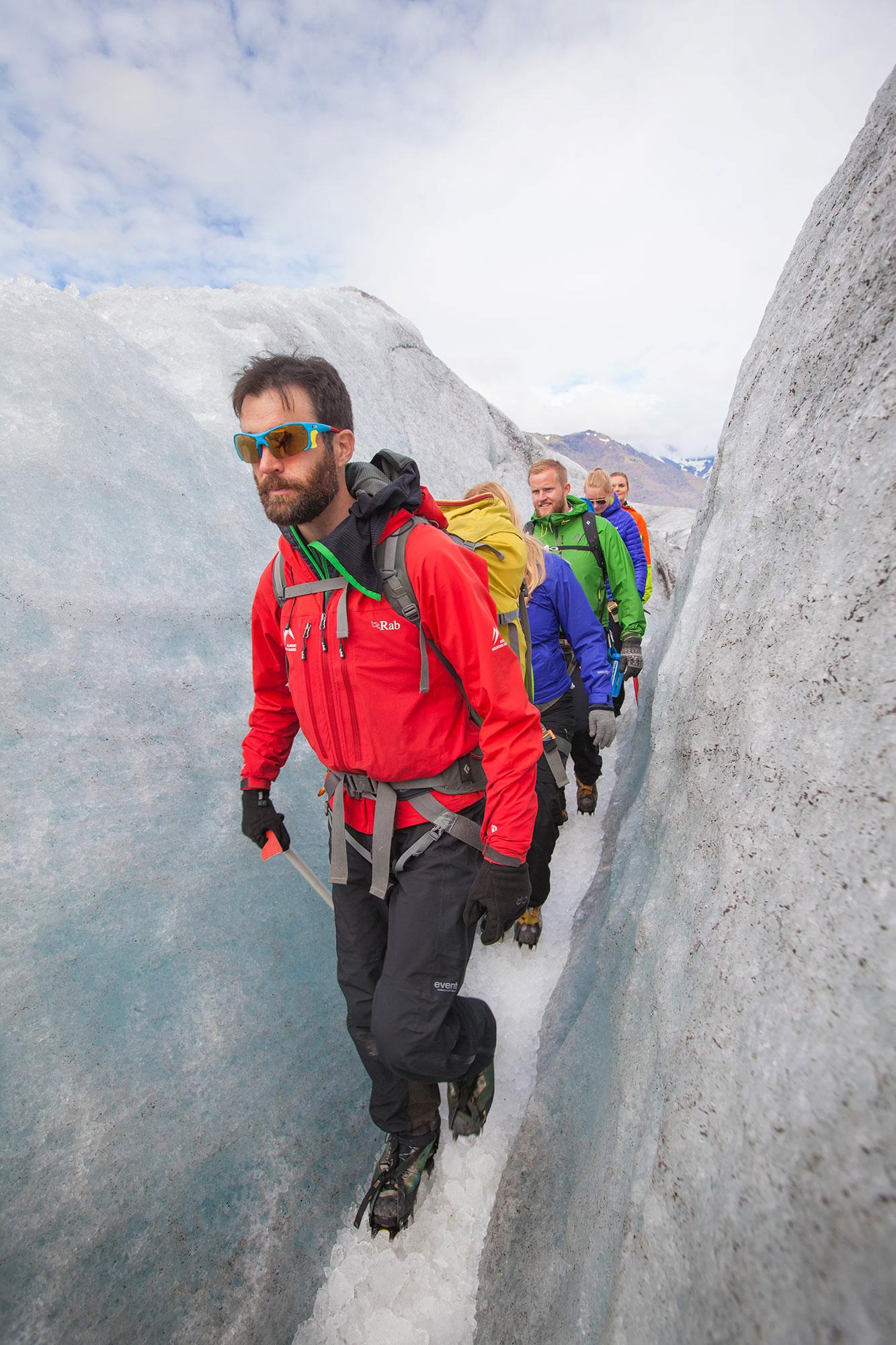 A guide leading a group through a crevasse on a Glacier Walk.