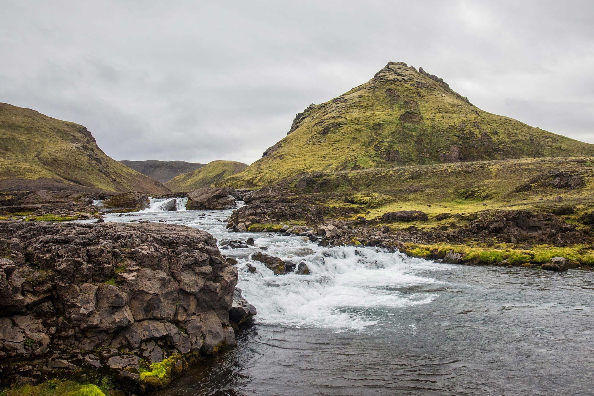 A lake flowing through mossy Icelandic nature