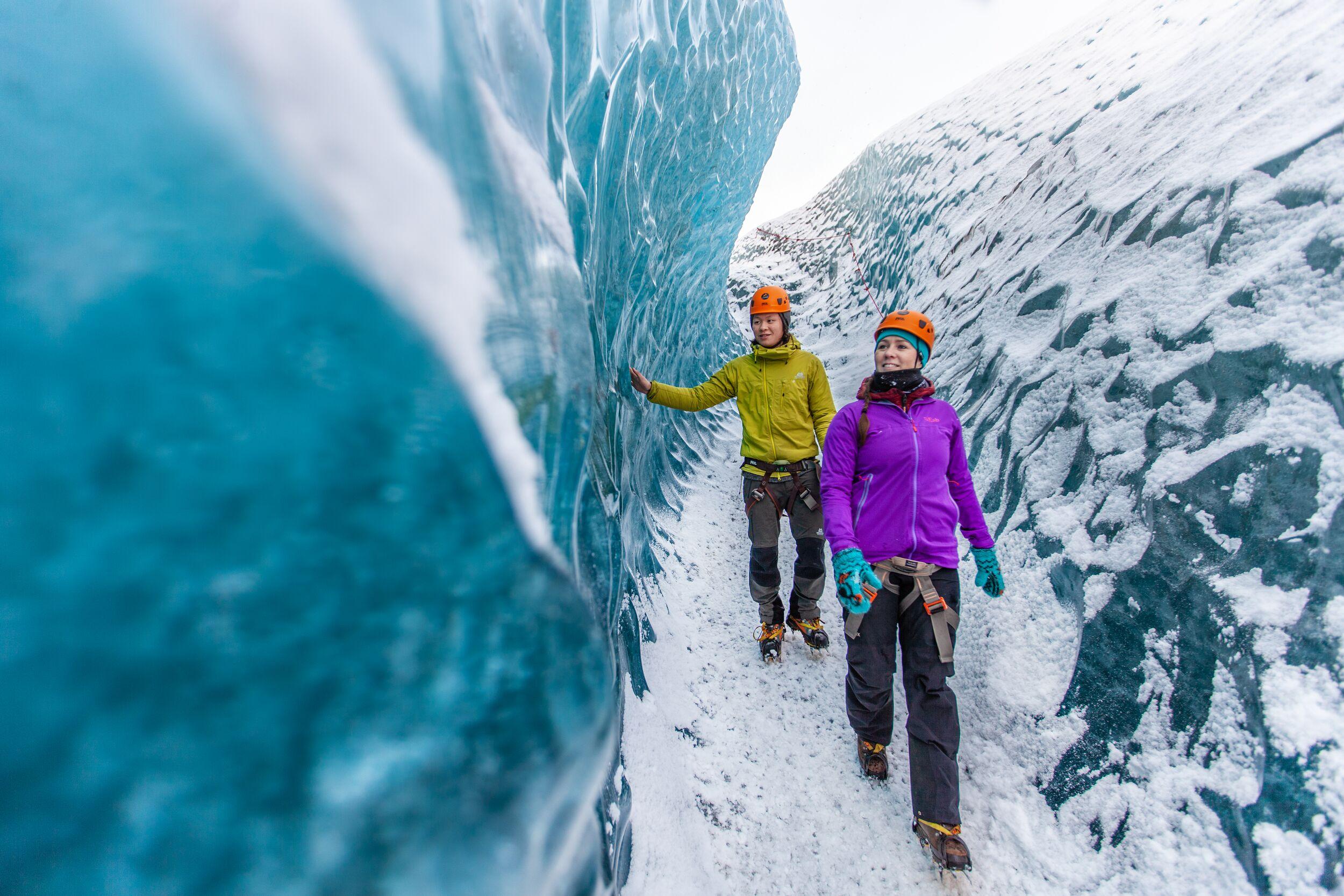 two people walking on blue ice
