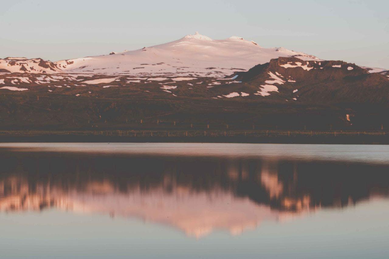 A summer view of Snæfellsjökull glacier with the glacier reflected in the sea