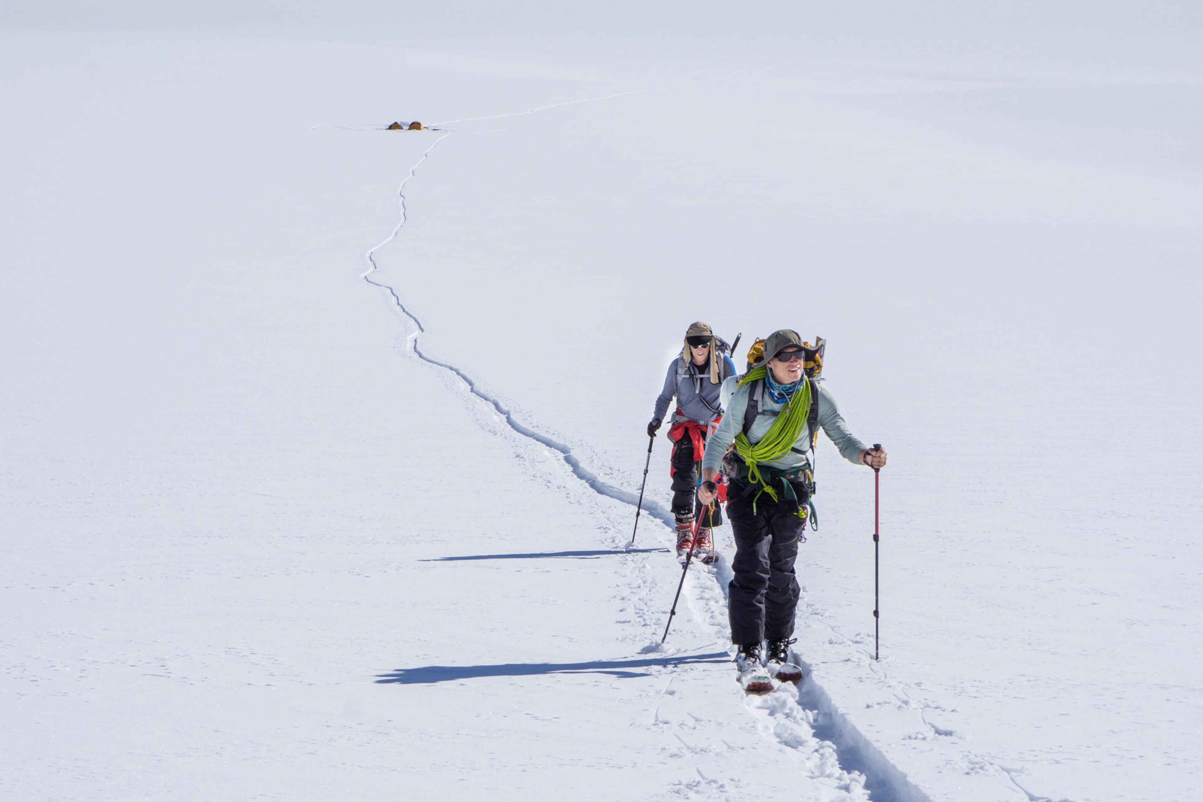Skiing higher up on the glacier, camp below in the background