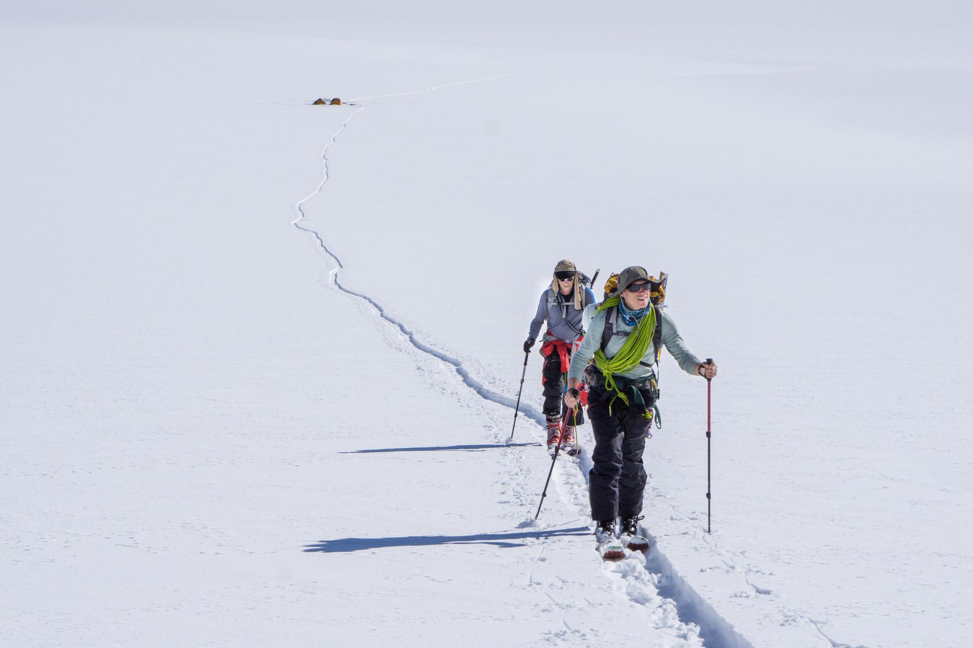 Skiing higher up on the glacier, camp below in the background