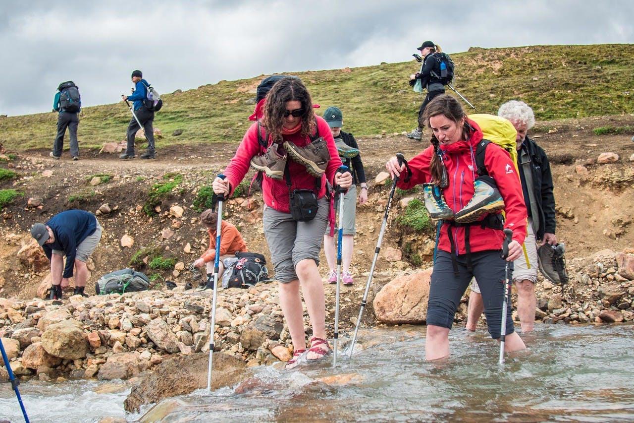 Hikers fording a river
