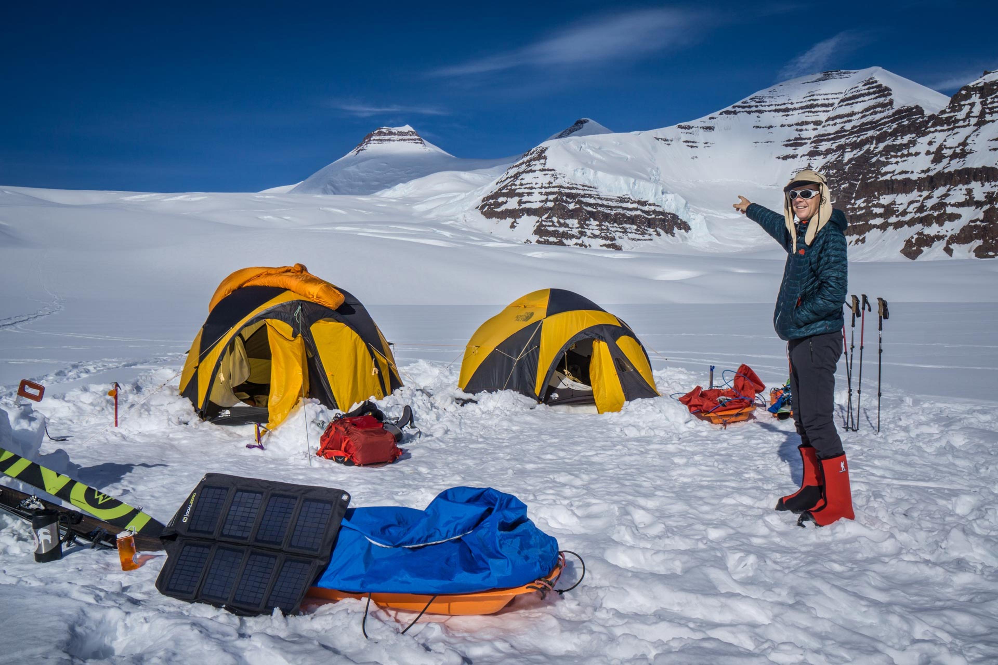 Expedition member pointing towards the top of mt. Gunnbjorn