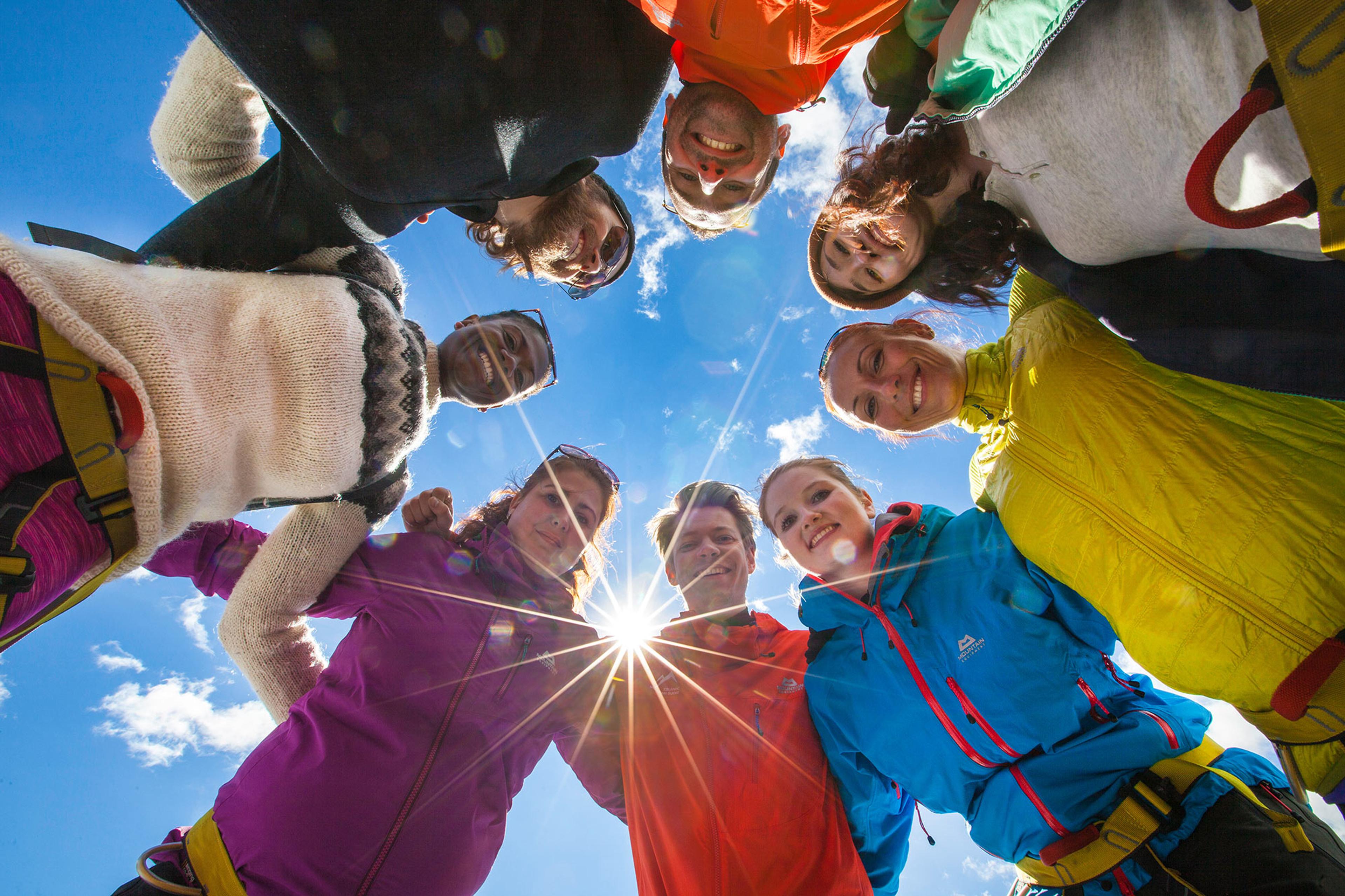 Group photo of glacier walkers forming a circle taken from below