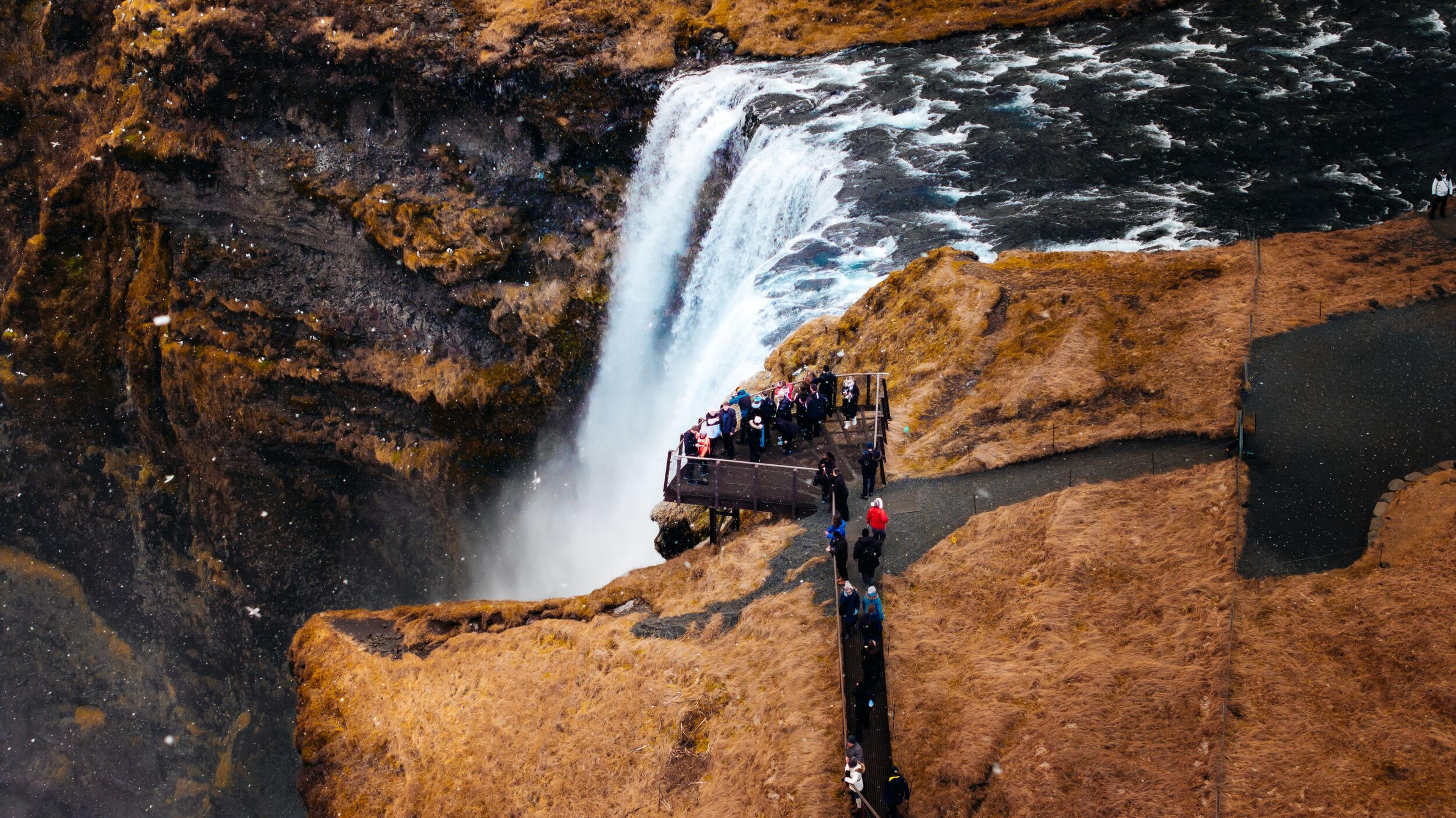 people viewing a waterfall