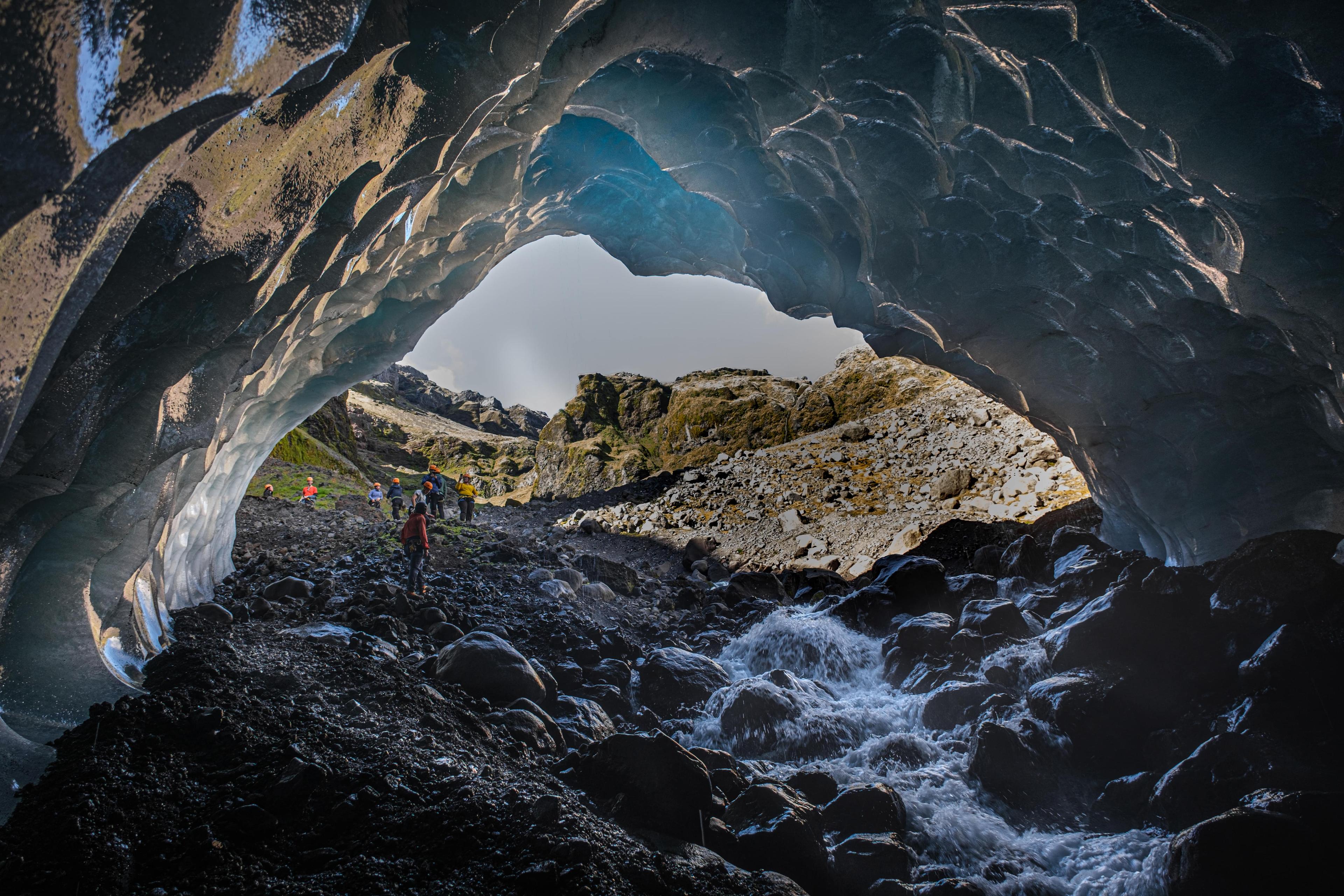 Glacial stream flowing in a blue ice cave.