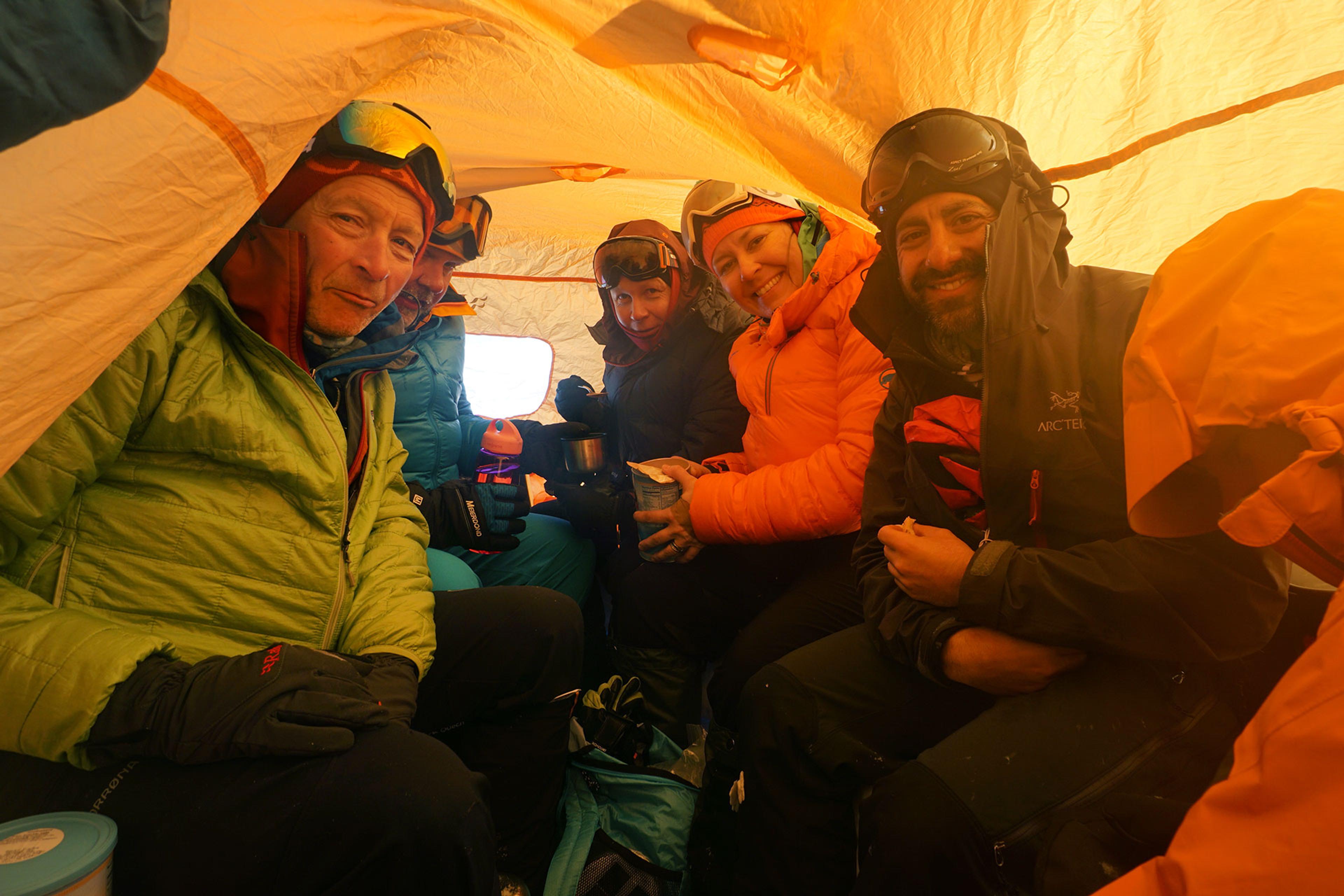 People inside an emergency shelter in bad weather