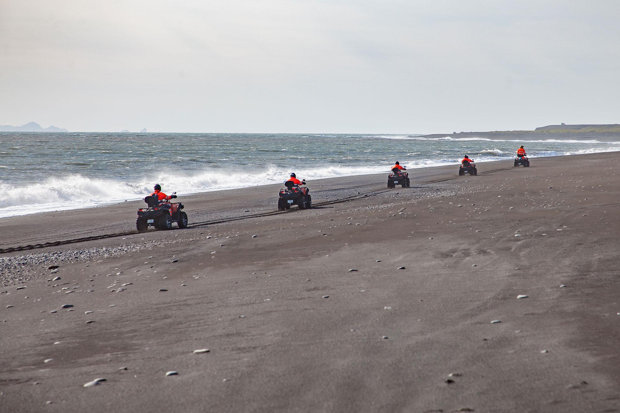 Riding on the black sand beach and the Atlantic ocean on ATV quad bikes