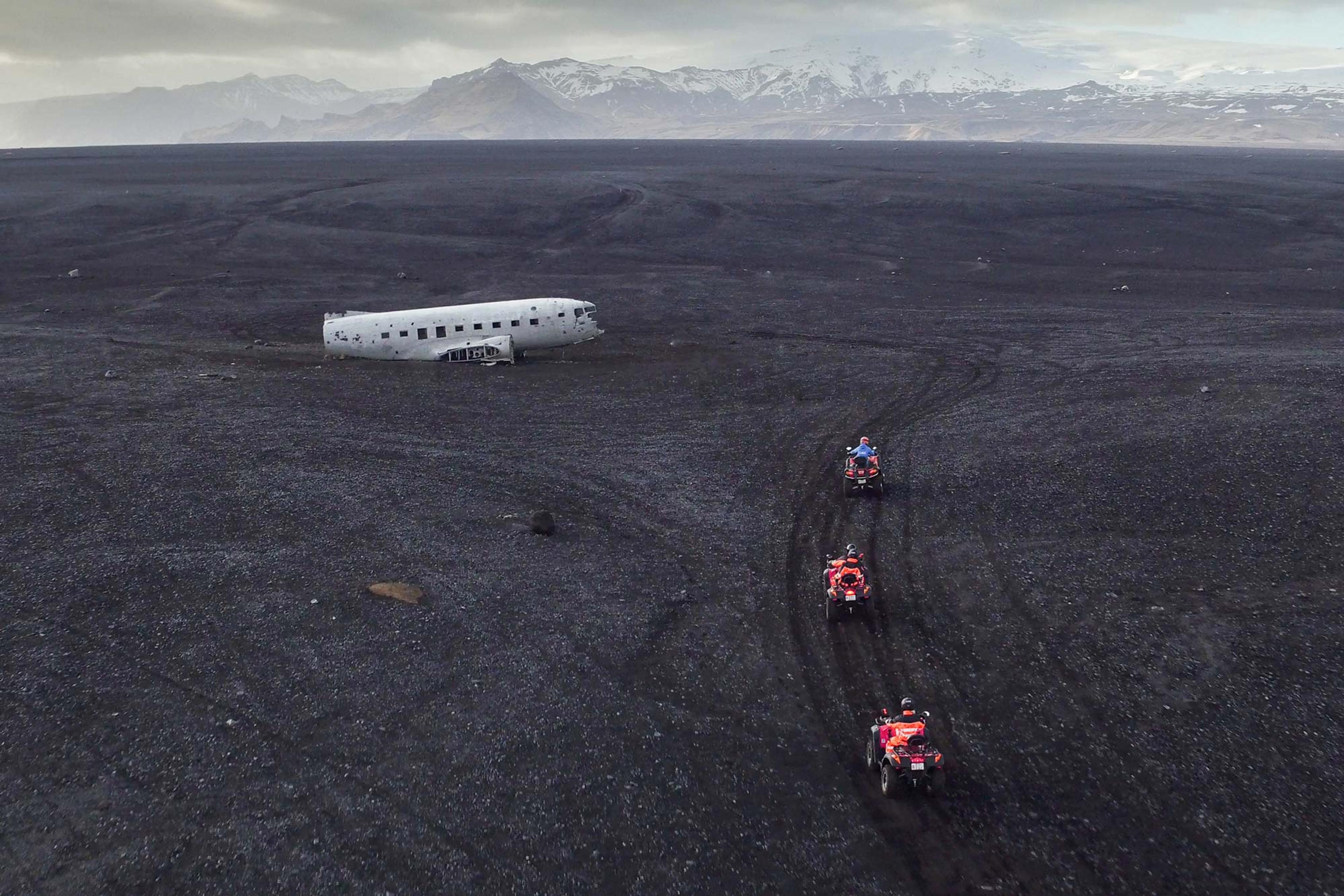 Group of ATV quad bike riders getting close to the famous old C-47 plane wreck